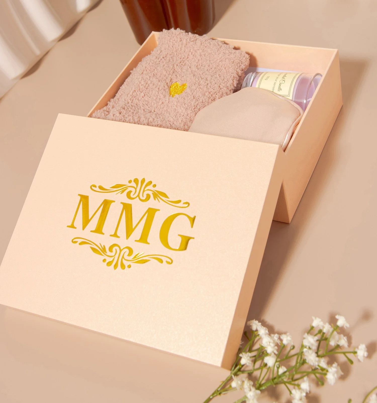 Luxury spa gift set by MyModaGlam featuring cozy socks, candle, and satin eye mask in elegant packaging