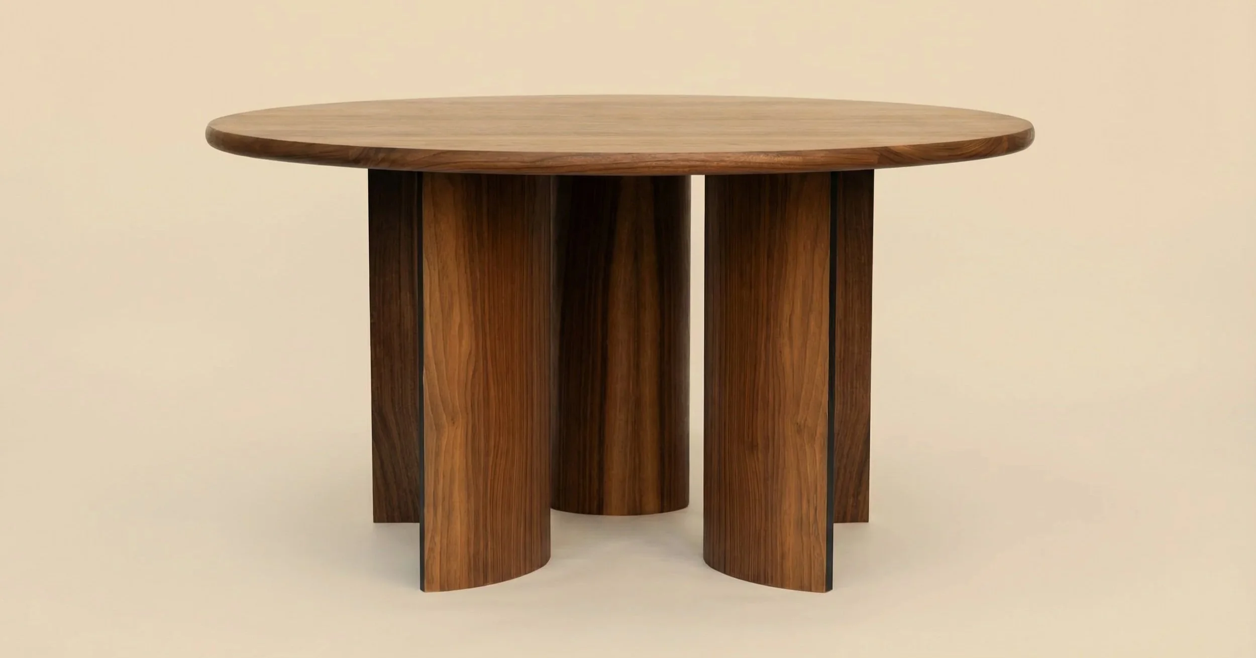 A round wooden table with unique curved legs against a cream-colored background.