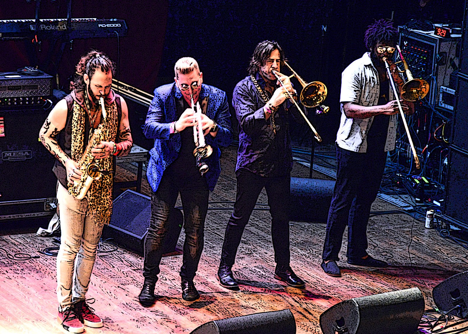 Four musicians playing instruments on stage, including saxophones, trumpet, and trombone, with sound equipment in the background.
