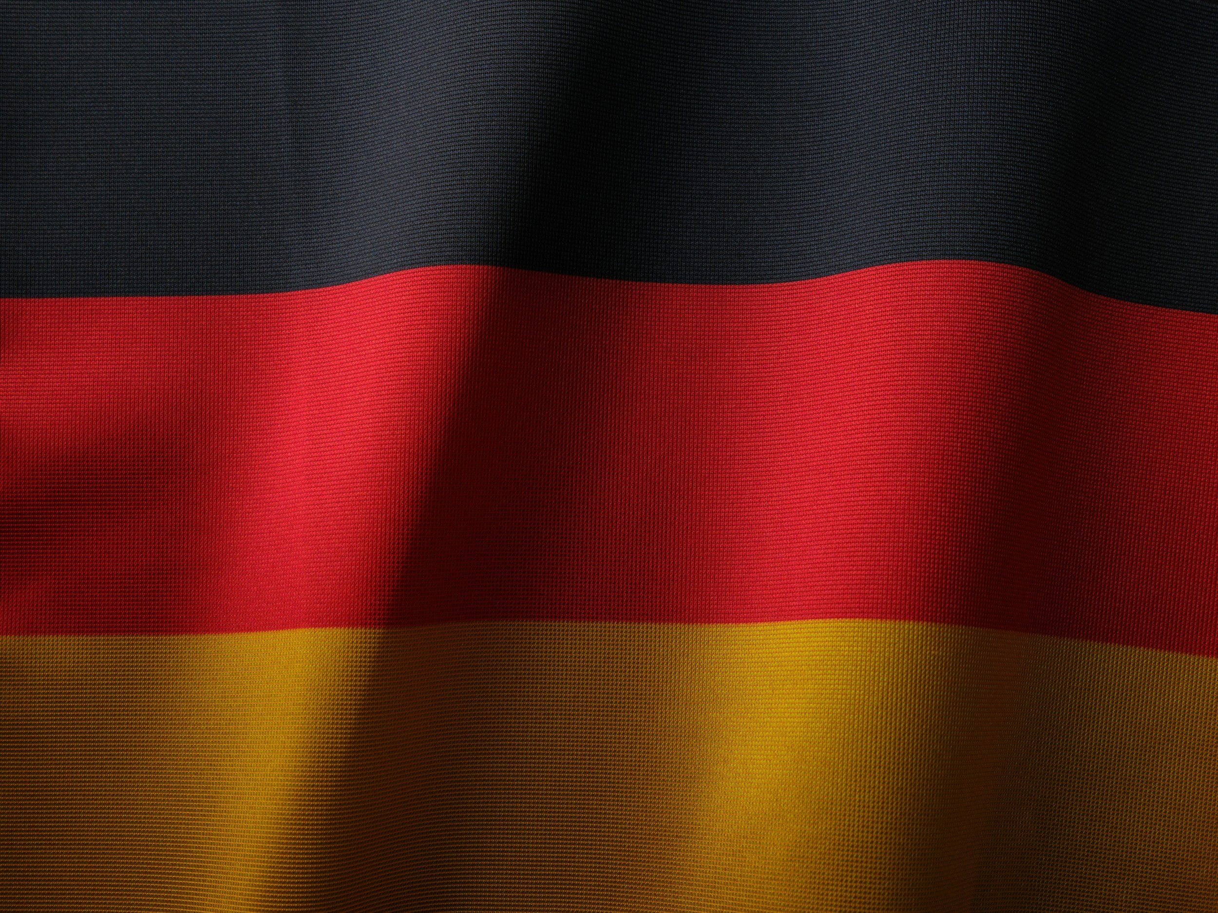 Close-up of the German flag with black, red, and gold horizontal stripes.