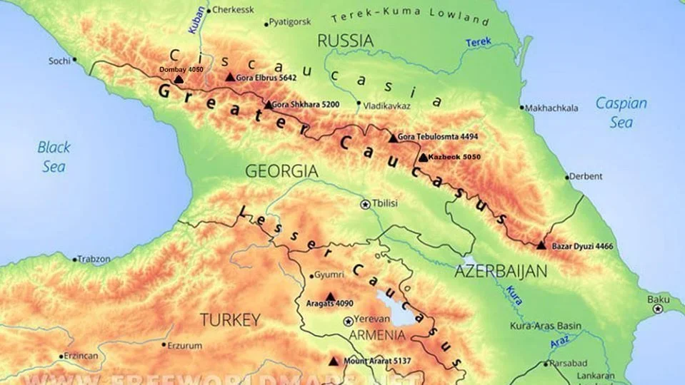 Map of the Caucasus region showing countries Georgia, Armenia, Azerbaijan, Russia, and Turkey. Features mountain ranges, mountain heights, and major cities like Tbilisi, Baku, Erevan, and Sochi, along with notable peaks and geographical features.