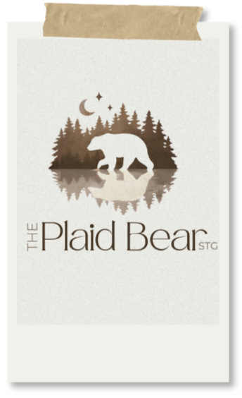 A book cover titled "The Plaid Bear" featuring a silhouette of a bear walking near water with a forest, moon, and stars in the background.