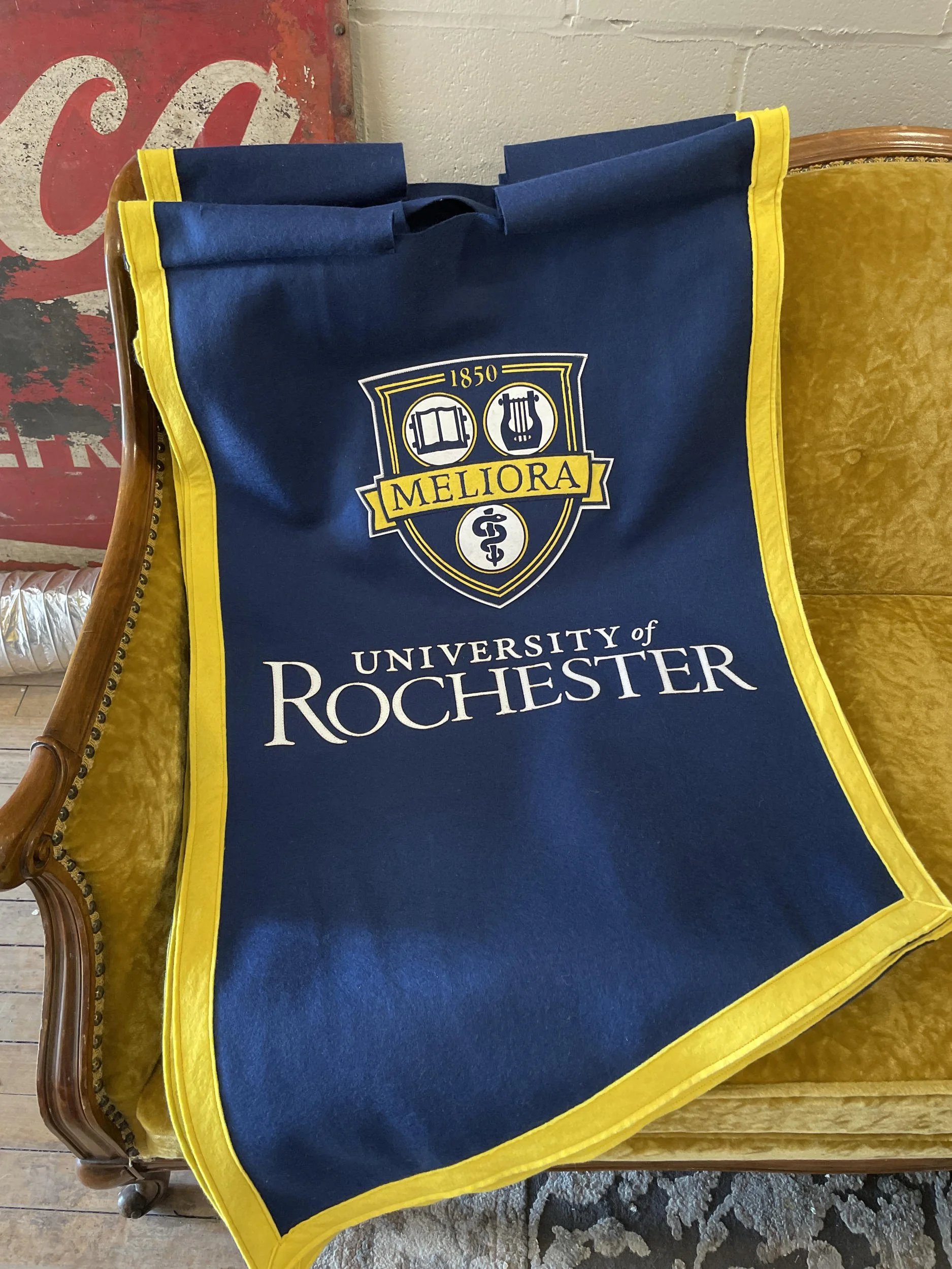 The final iteration of banners seen here are hand-sewn heavy felt. Felt banners had the weight to not blow in the wind as much as nylon, combined with long-term durability. 