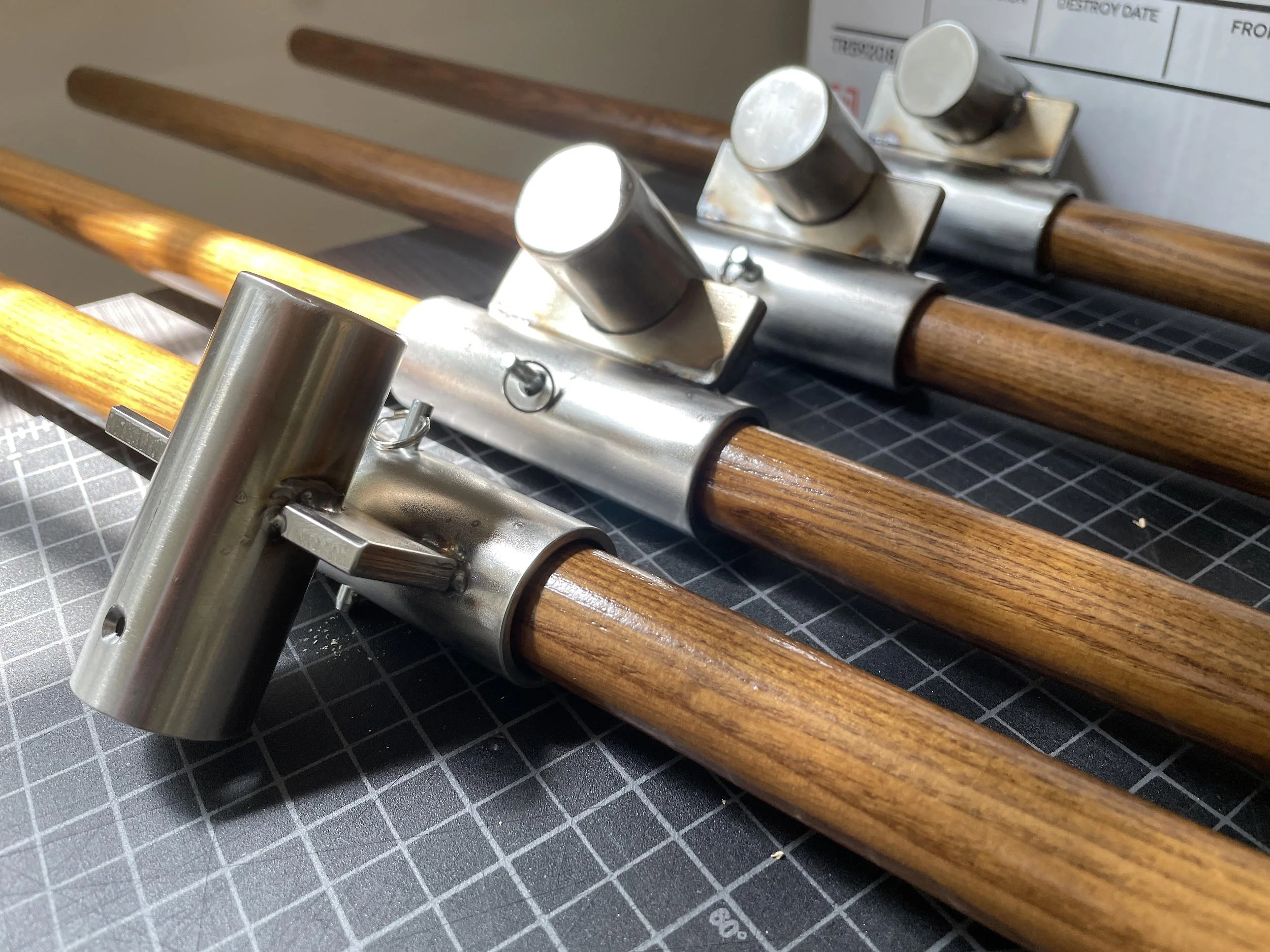 Traditional gonfalons have their crosspiece attached to the pole with a hook and loop method that works well when stationary, but waves excessively in the wind. I worked with the university's machine shop to design and build custom-made stainless ste