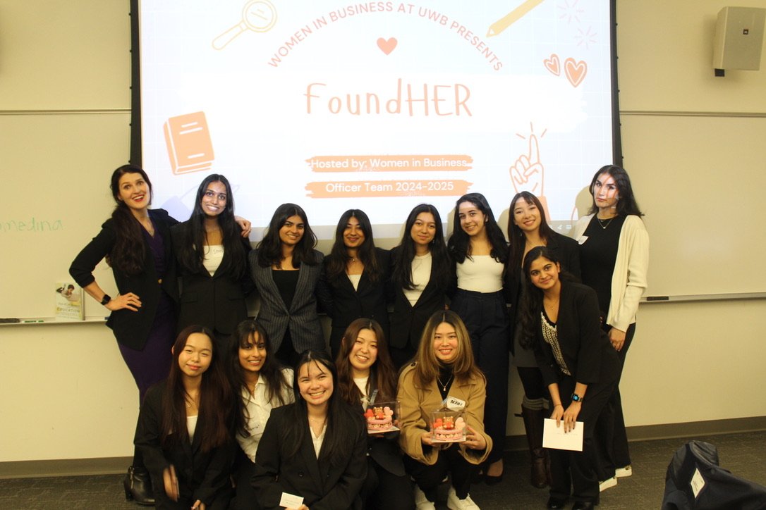 Group photo of all participants who placed first, second, or third in the case competition, standing together in a classroom setting after the awards were announced.