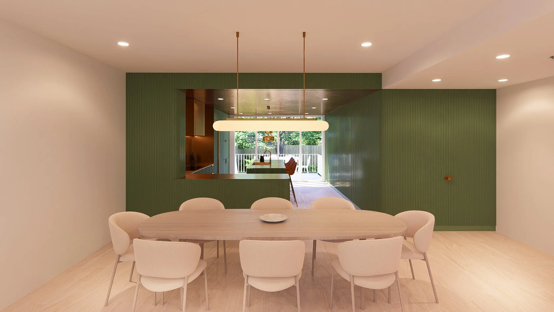 Dining room with oval wooden table, eight beige chairs, green accent wall, white ceiling with recessed lights, modern pendant light, view of kitchen and patio with outdoor furniture through sliding glass doors.
