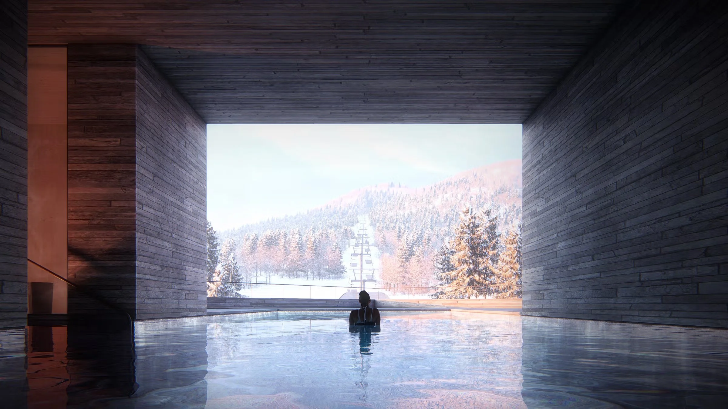 A person sitting in an indoor pool with large open window overlooking snow-covered trees and mountains.