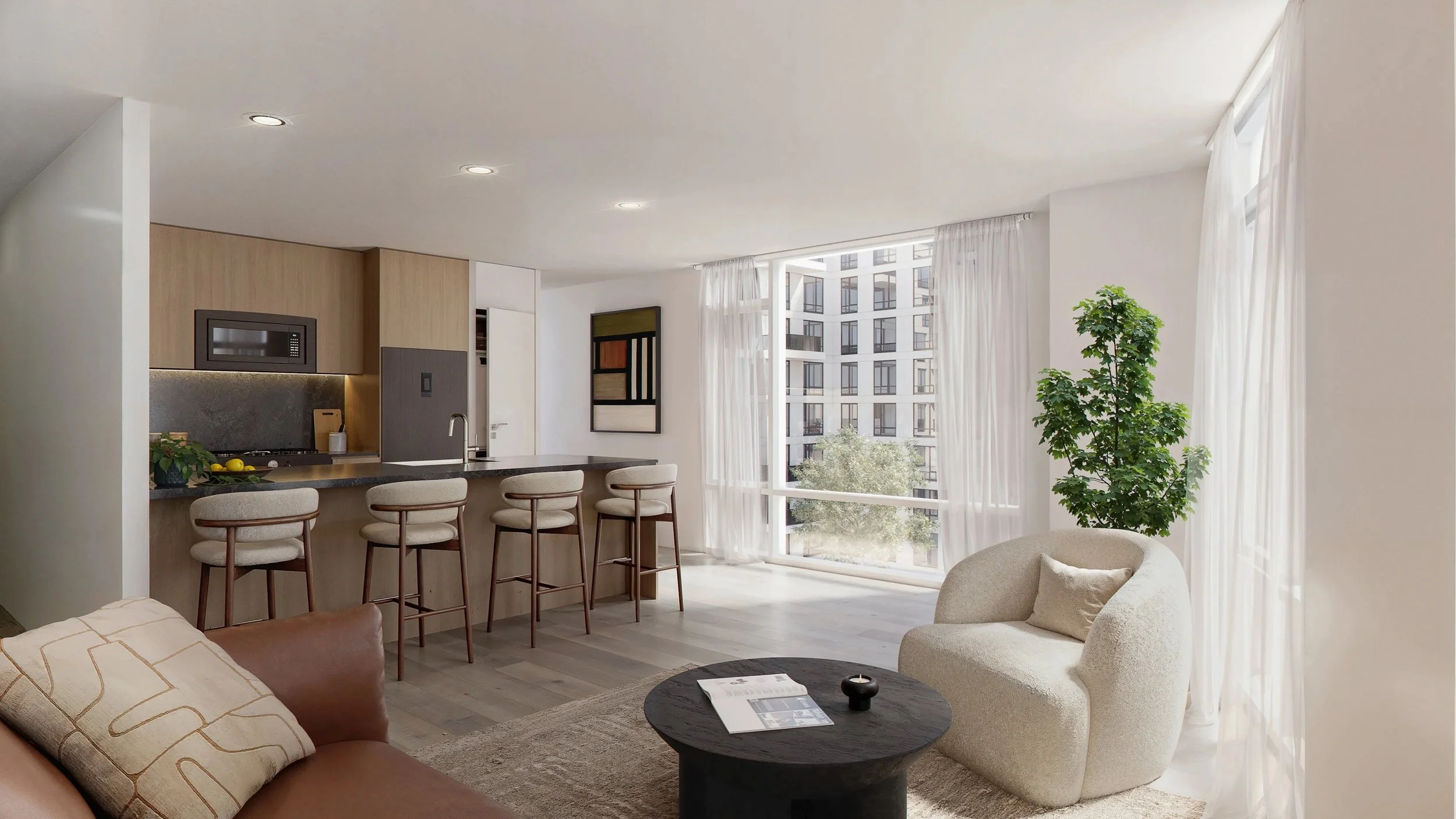 Modern living room with white walls, large windows with sheer curtains, green potted plant, beige sofa with cushions, black coffee table with magazine and candle, kitchen area with bar stools, view of neighboring apartment building.