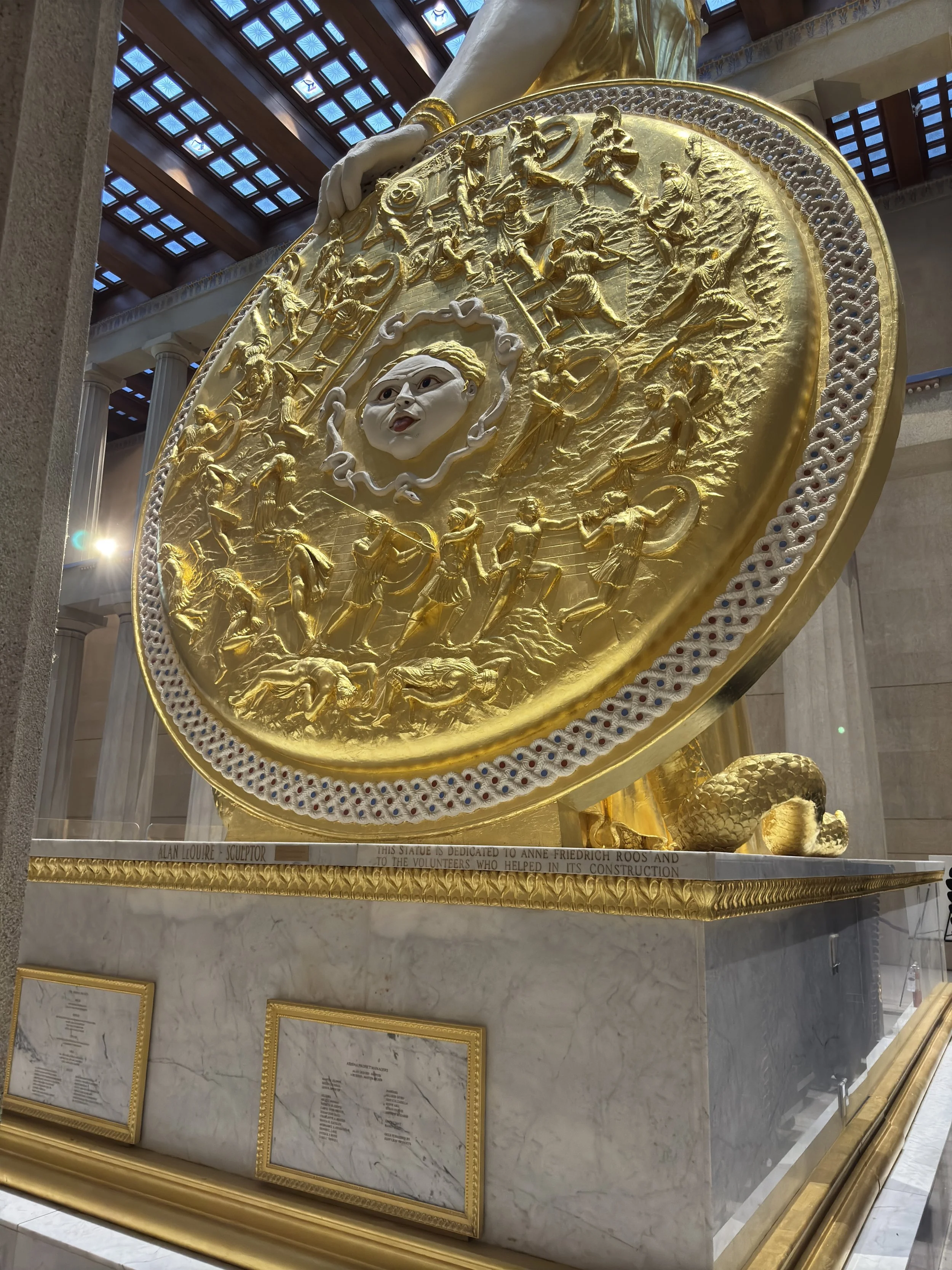 Golden Shield held by Athena