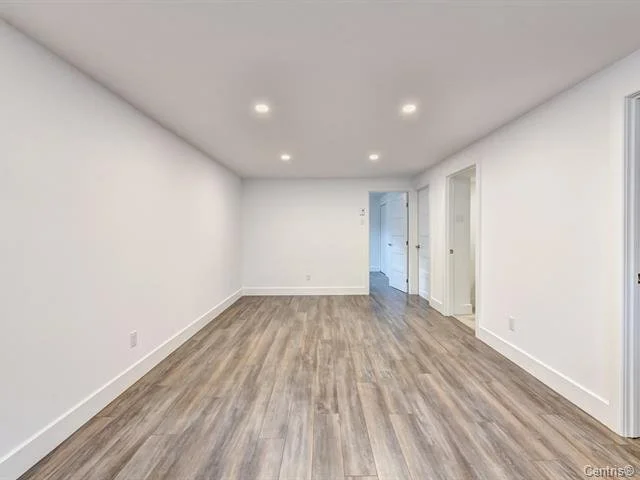Basement remodel in a Dollard-Des-Ormeaux residence, West Island Montreal, featuring a smart redistribution of space by transforming the basement living room into a cozier area, while adding a teenager bedroom, a separate home office and a bathroom t