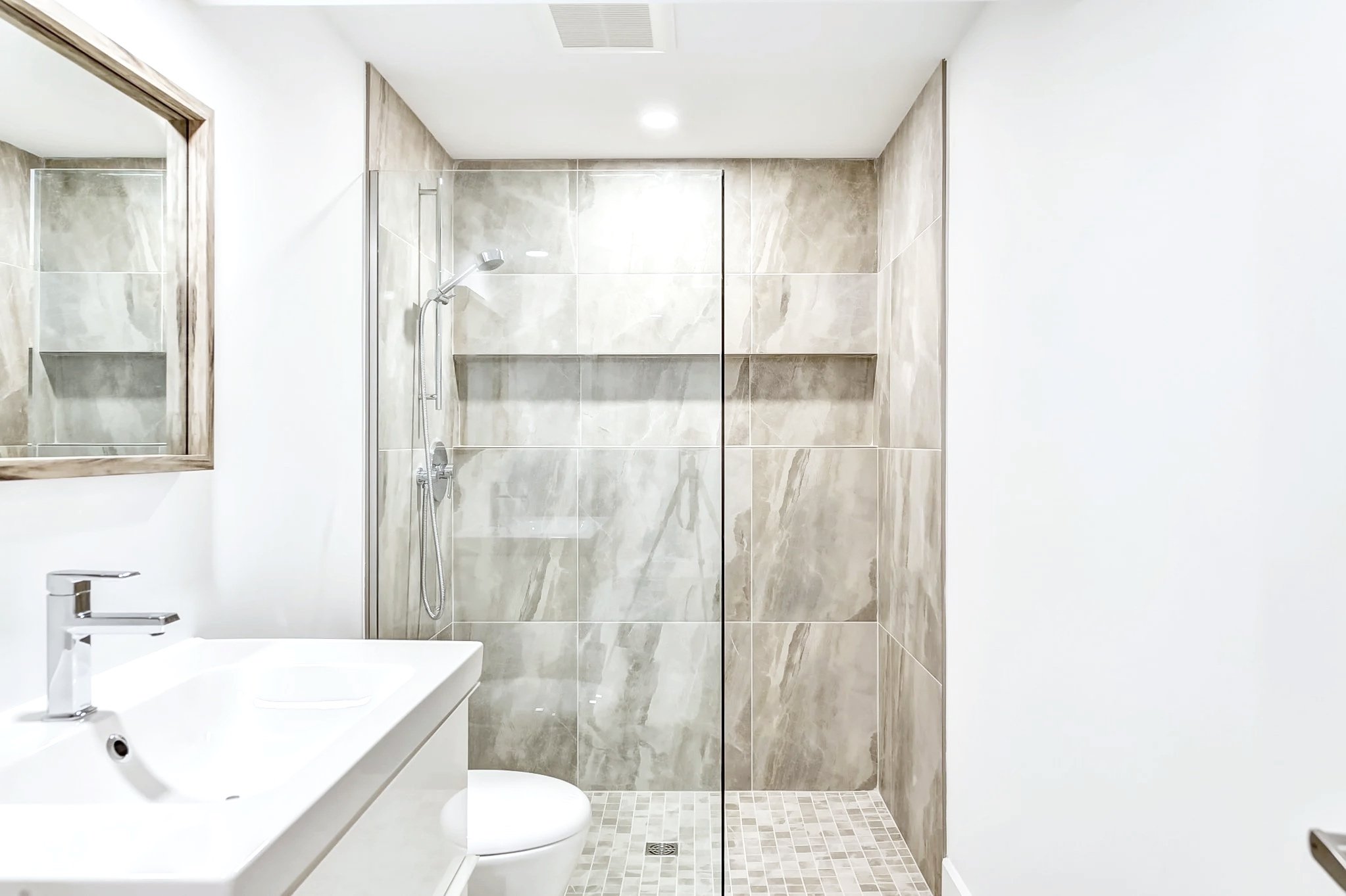 New basement bathroom with shower in Pointe-Claire, West Island Montreal, designed for a teenager’s suite in a bungalow basement, combining functionality with a clean, contemporary look