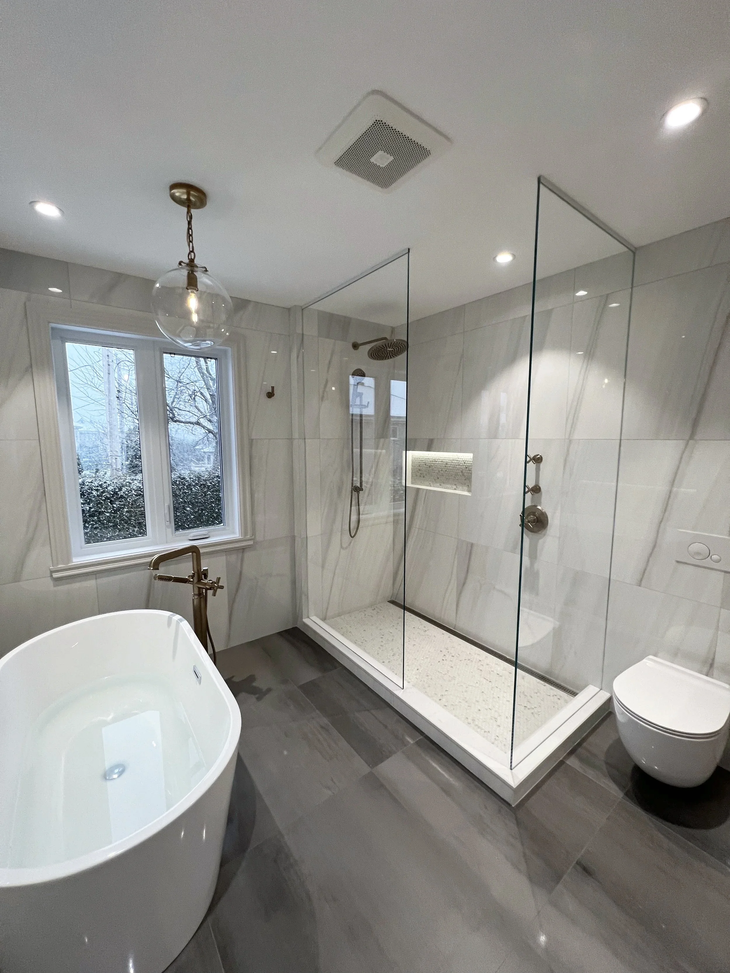 Master bathroom remodel in Dollard-des-Ormeaux (DDO), West Island Montreal, featuring designer-selected tiles and fixtures for a refined, standout result