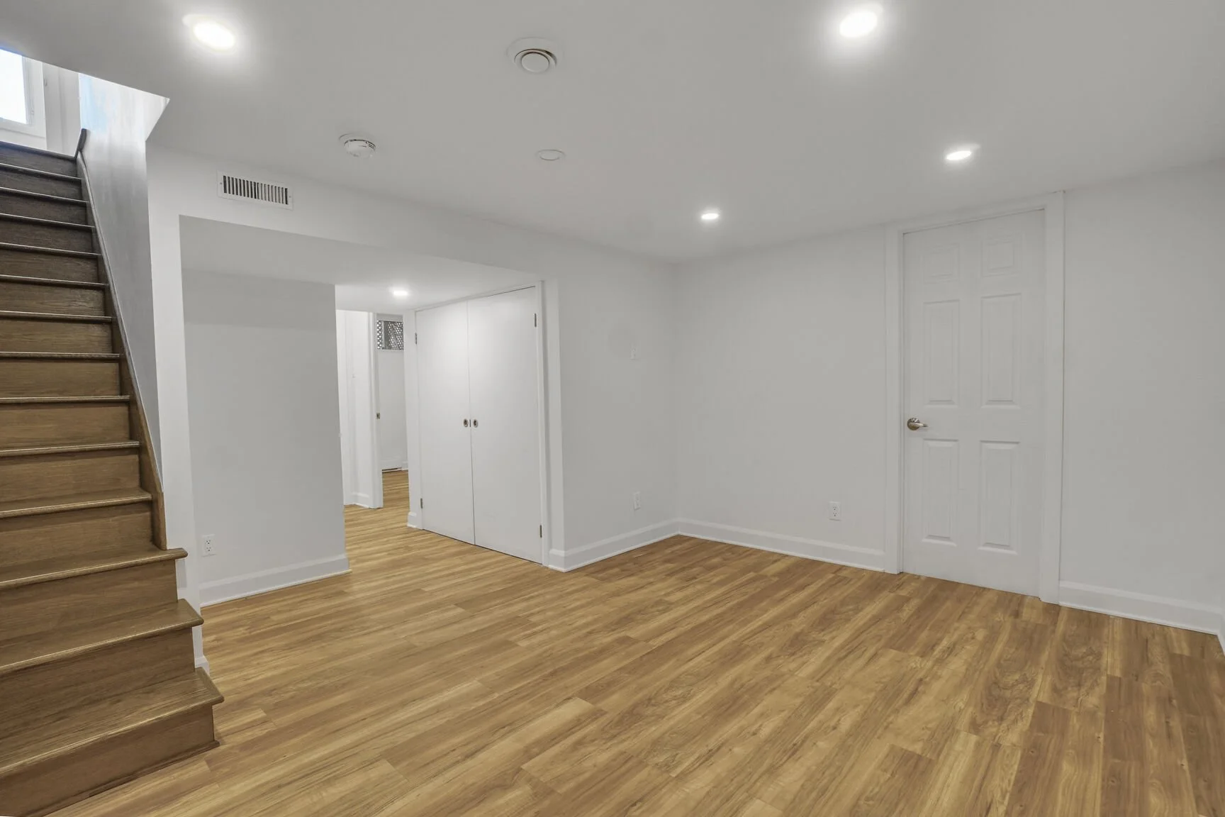 Full basement transformation in a Pointe-Claire home, West Island Montreal, converting an unfinished space into a bright, organized, and functional area. The remodel, tailored for a growing family, features a playroom, laundry room, small bedroom and