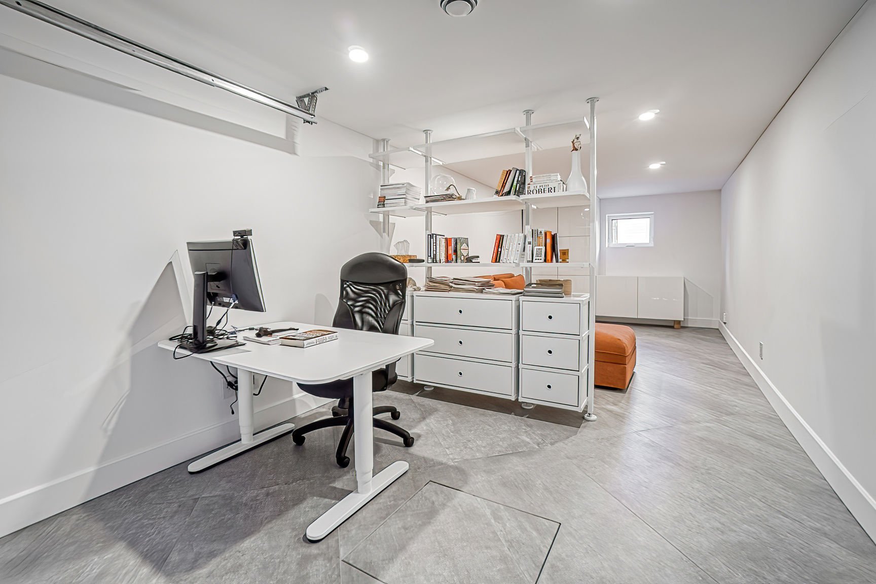 Complete garage-to-office transformation in Pierrefonds, West Island Montreal, featuring diagonal large-format ceramic tile installation, heated flooring for added comfort, and a white palette for a modern, timeless look
