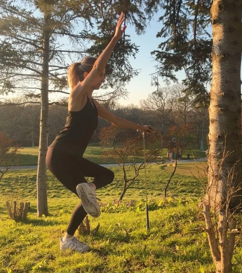 Hellen Barlow at East Sussex National Golf Club doing some warm up yoga for golfers moves to get ready for a round of golf.