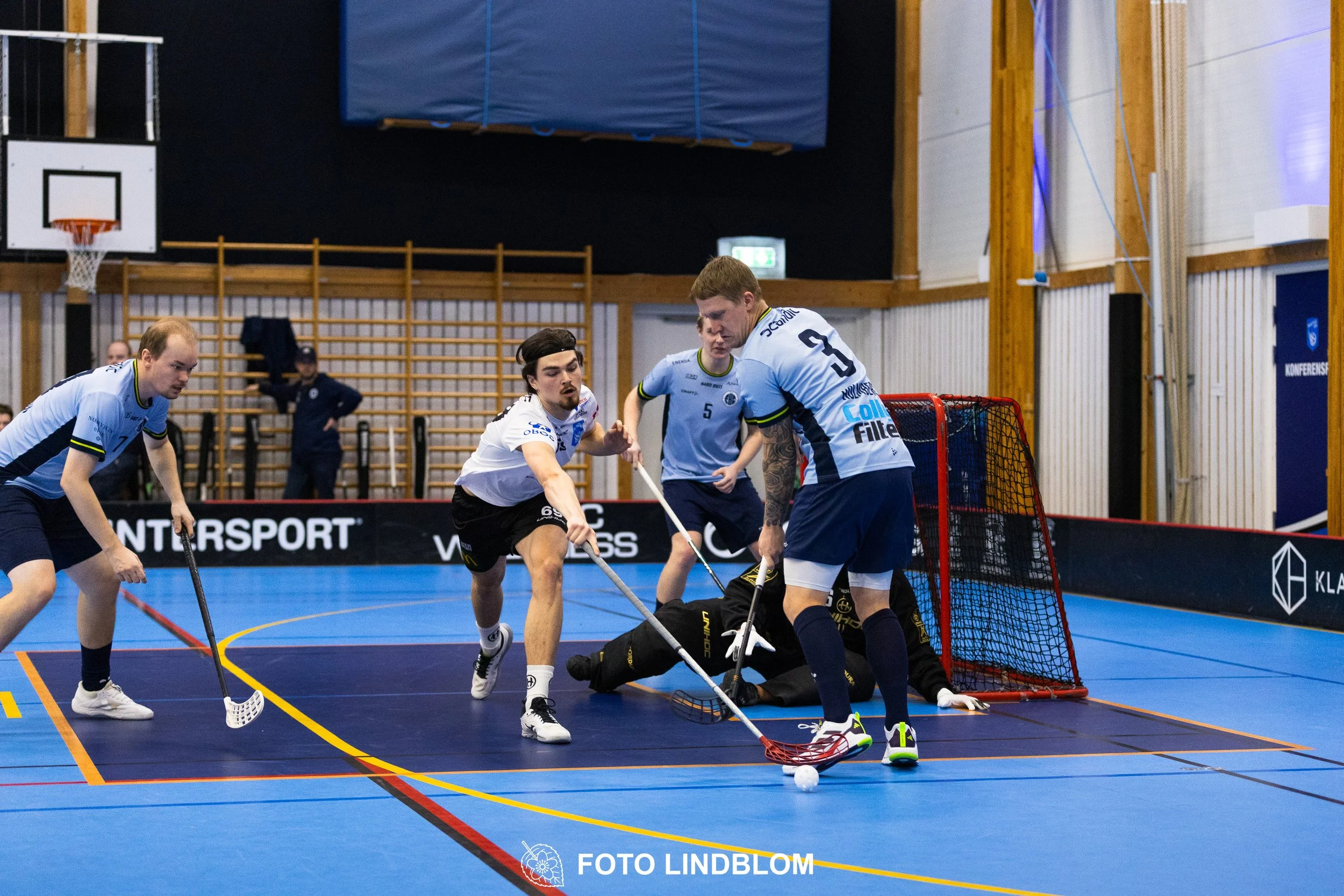 A picture of men playing floorball in Nacka IBK and FBC Sollentuna team gear