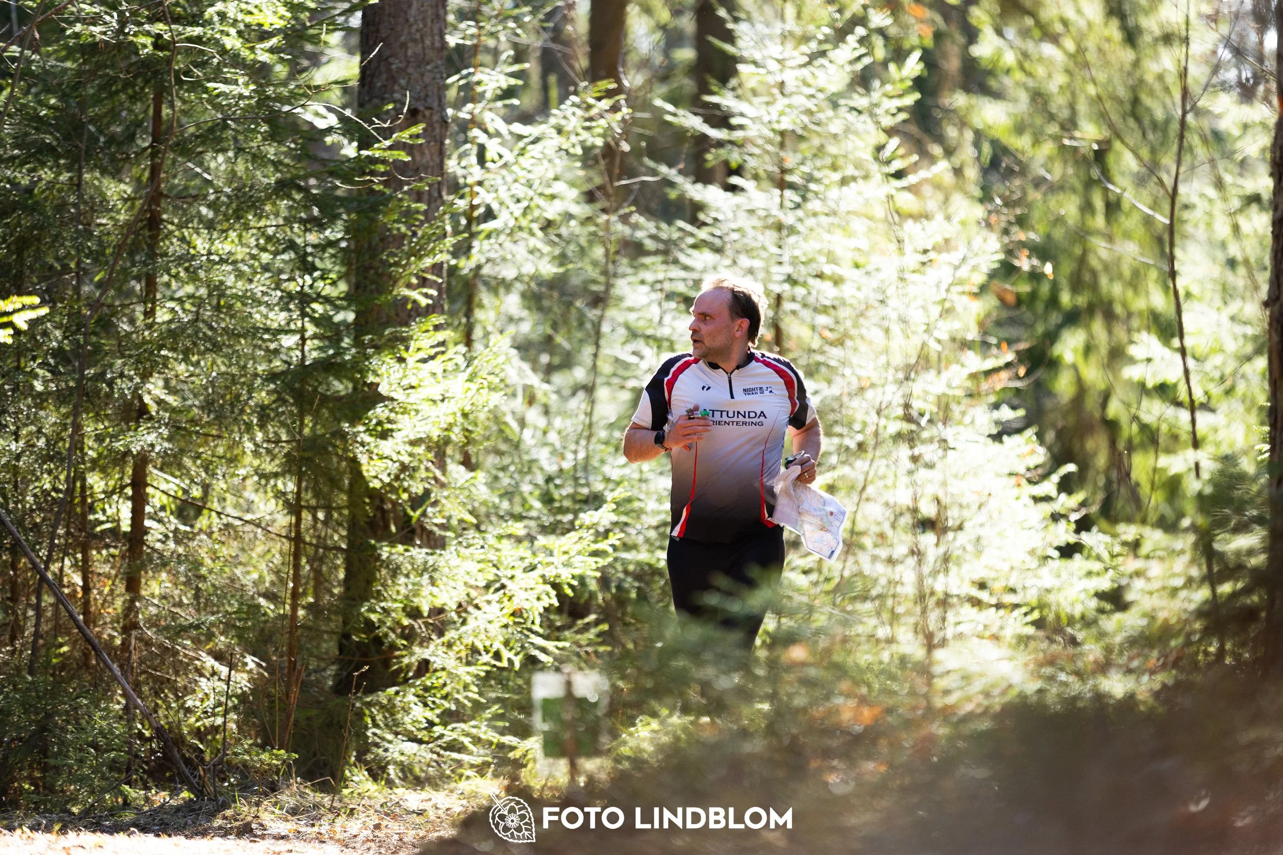 A forest-stage photo from the 2026 Nyköpingsorienteringen orienteering event, taken by Foto Lindblom.