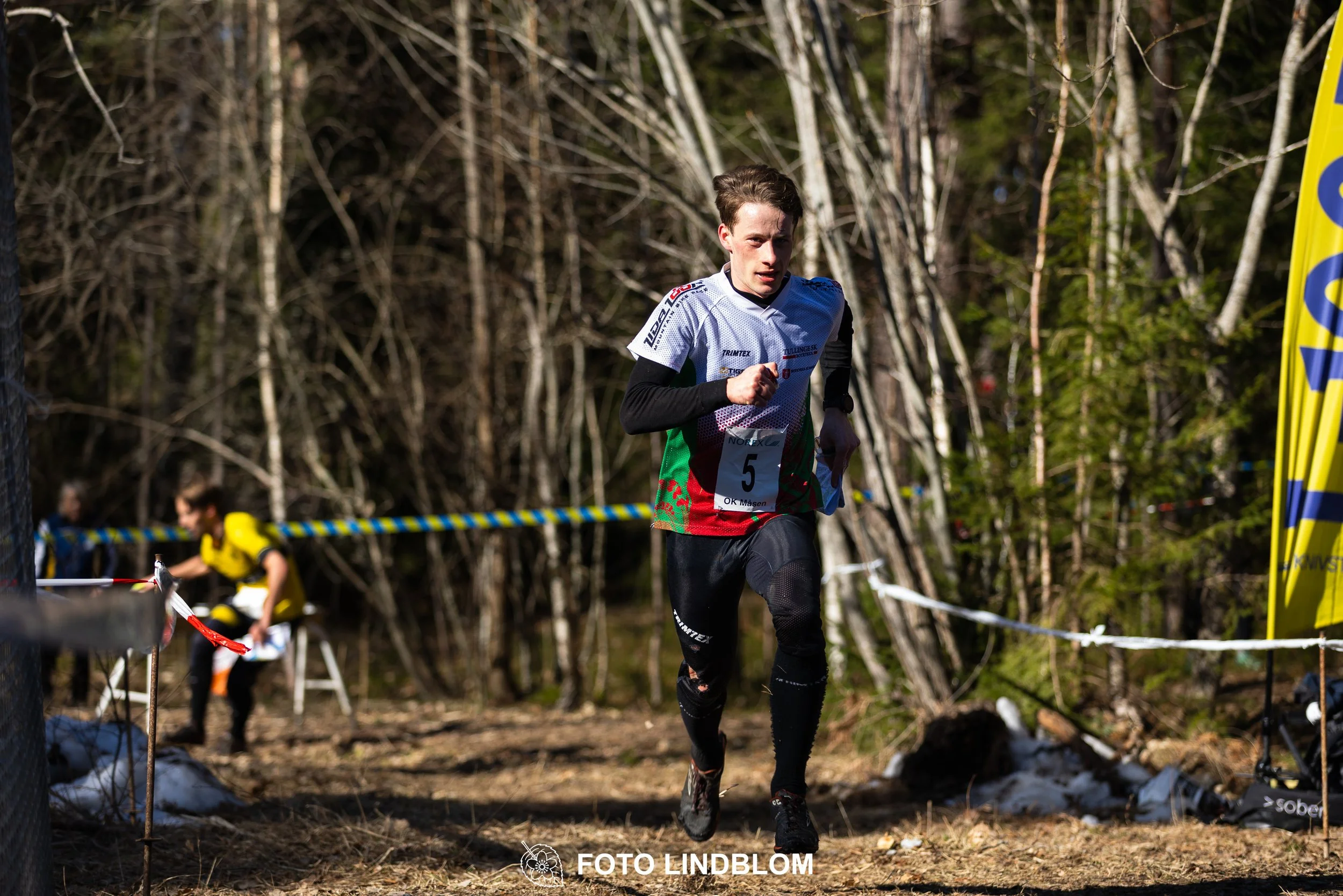 A relay-stage photo from Måsenstafetten 2026, featuring team-based orienteering competition, showing Simon Imark, taken by Foto Lindblom.