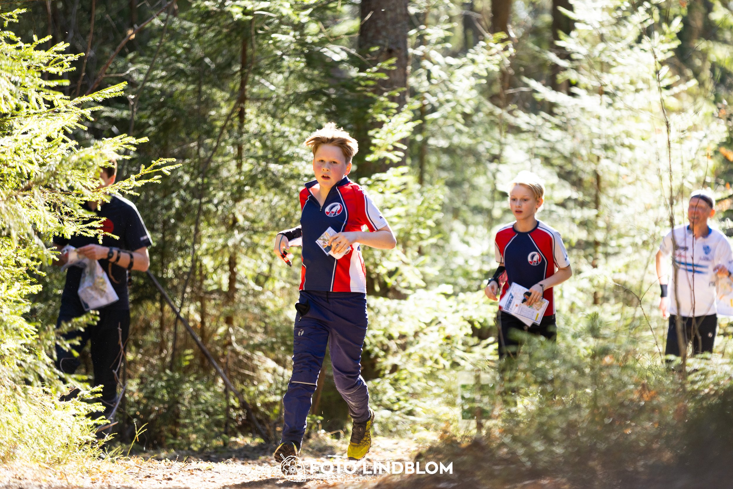 A forest-stage photo from the 2026 Nyköpingsorienteringen orienteering event, taken by Foto Lindblom.