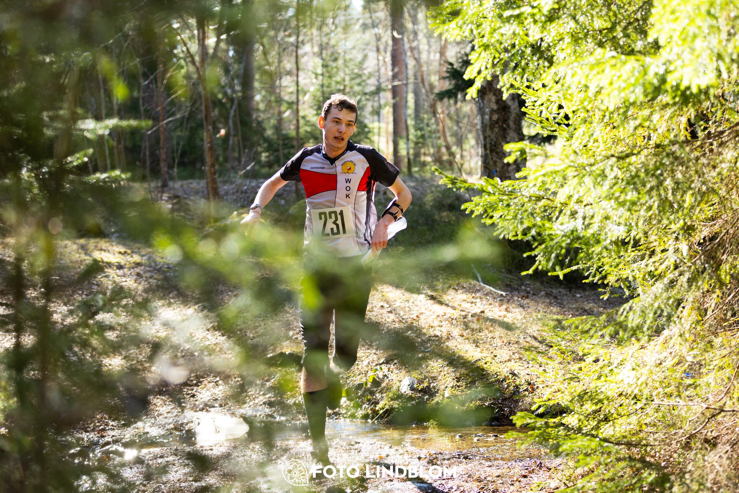 A forest-stage photo from the 2026 Nyköpingsorienteringen orienteering event, taken by Foto Lindblom.