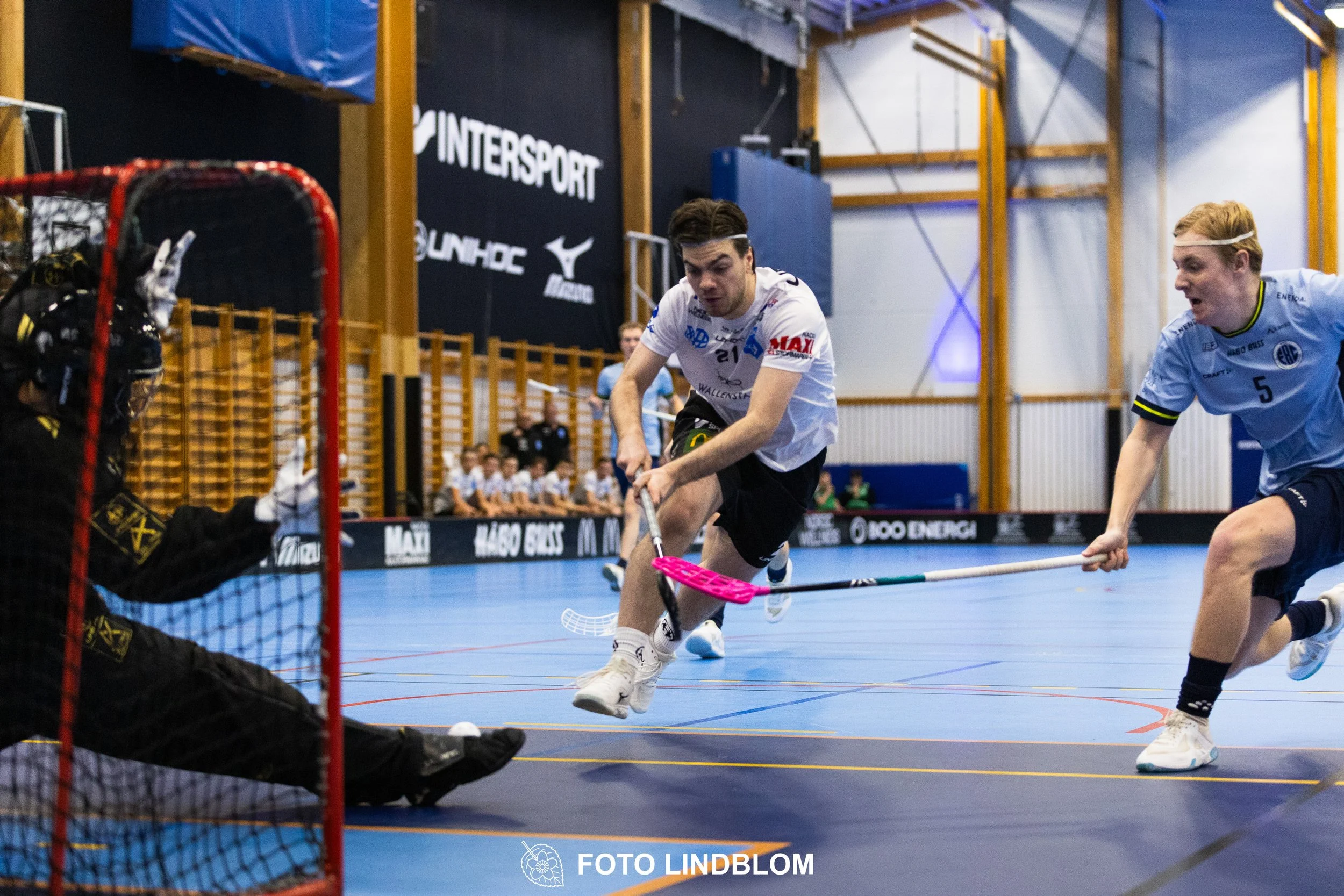 A picture of men playing floorball in Nacka IBK and FBC Sollentuna team gear