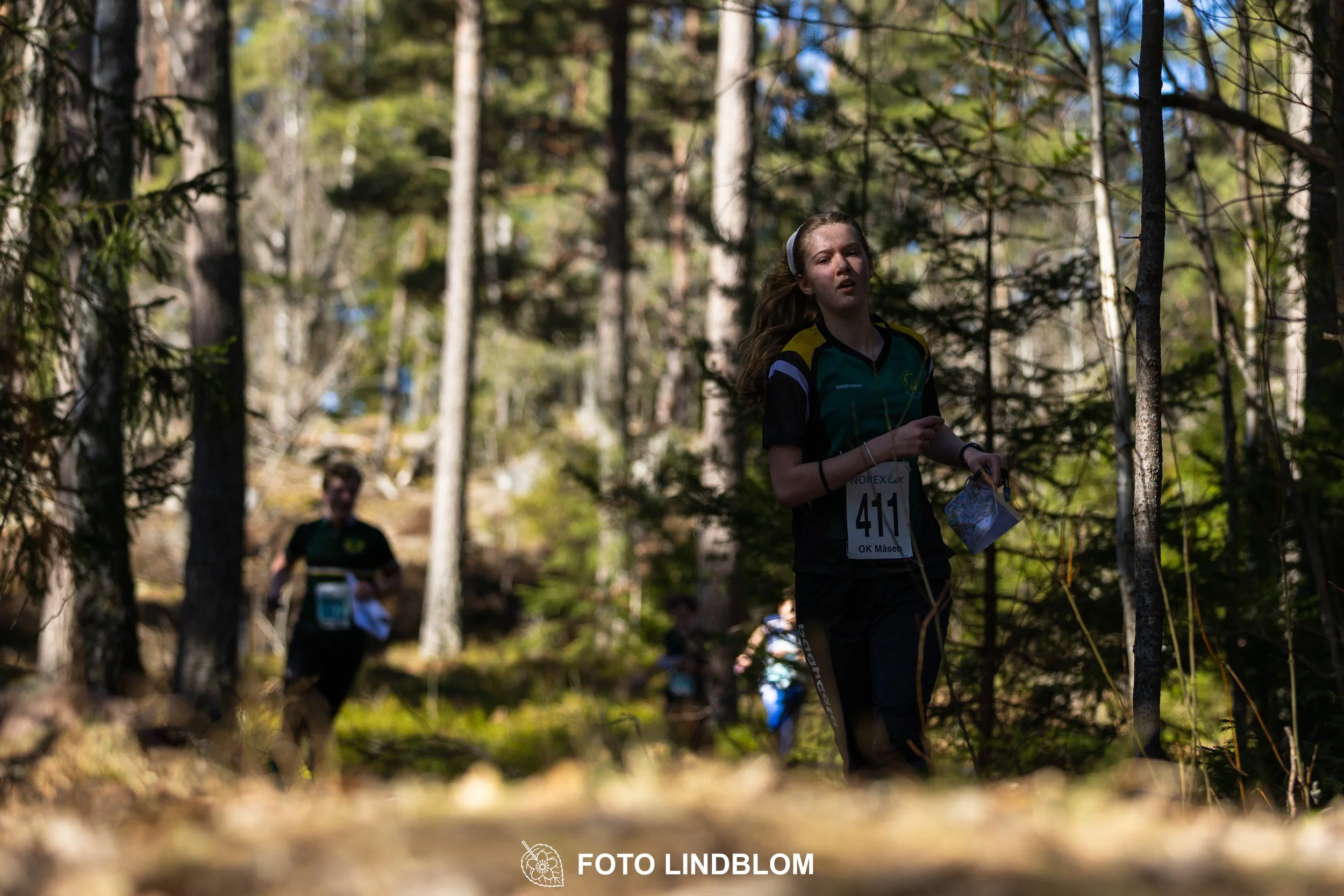 A relay-stage photo from Måsenstafetten 2026, featuring team-based orienteering competition, taken by Foto Lindblom.