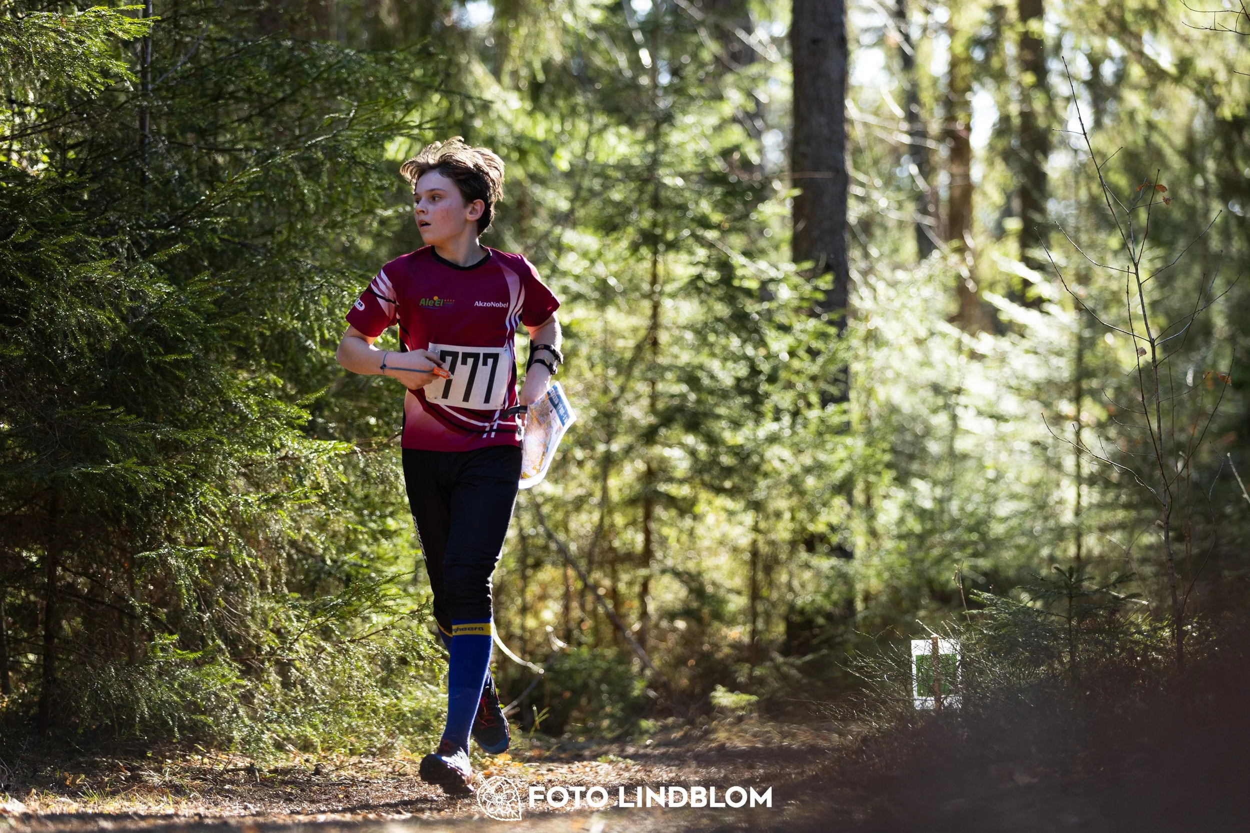 A forest-stage photo from the 2026 Nyköpingsorienteringen orienteering event, taken by Foto Lindblom.