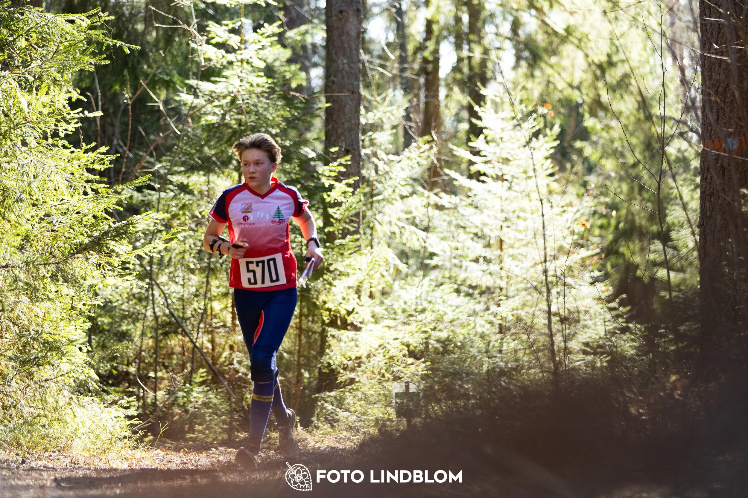 A forest-stage photo from the 2026 Nyköpingsorienteringen orienteering event, taken by Foto Lindblom.
