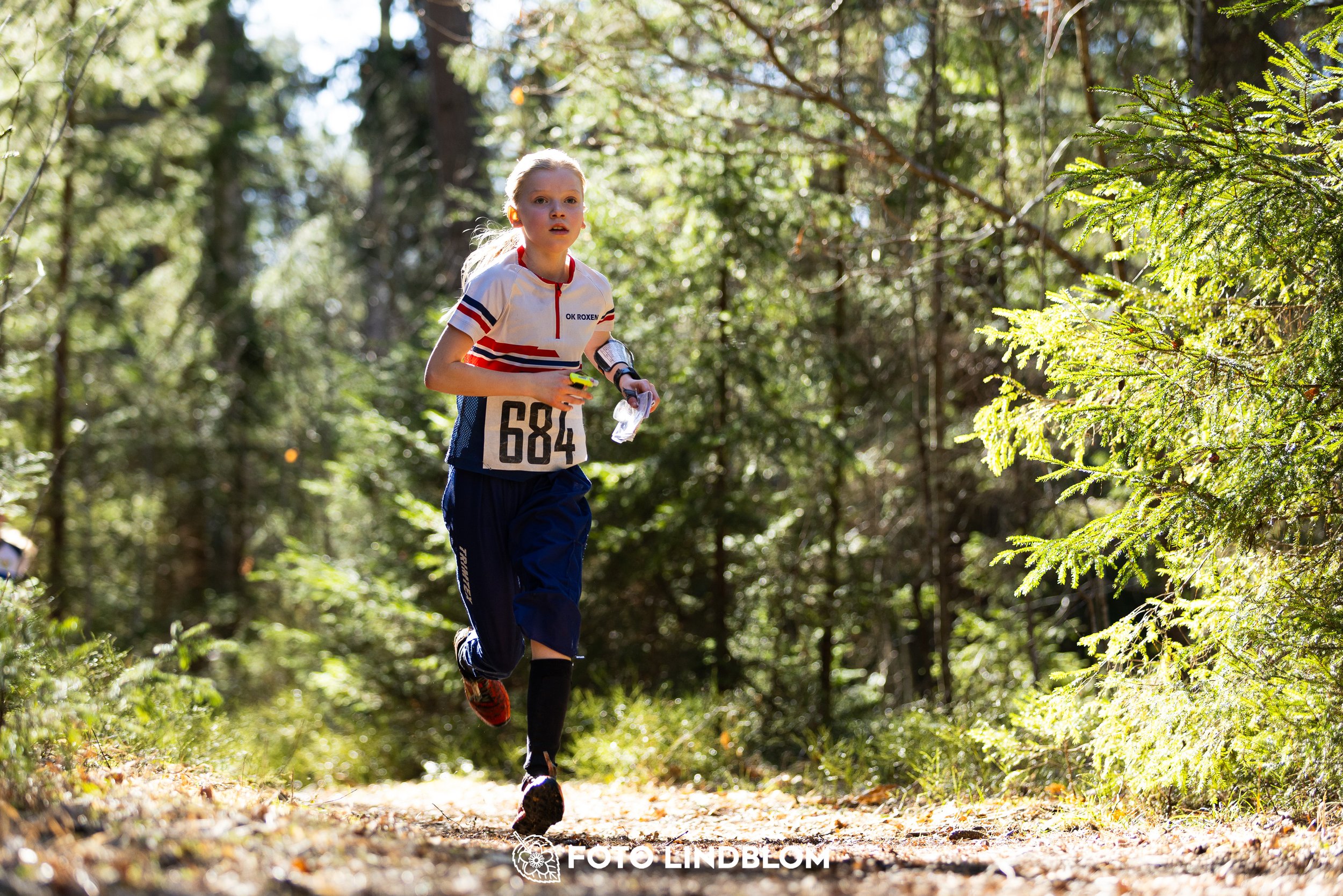 A forest-stage photo from the 2026 Nyköpingsorienteringen orienteering event, taken by Foto Lindblom.