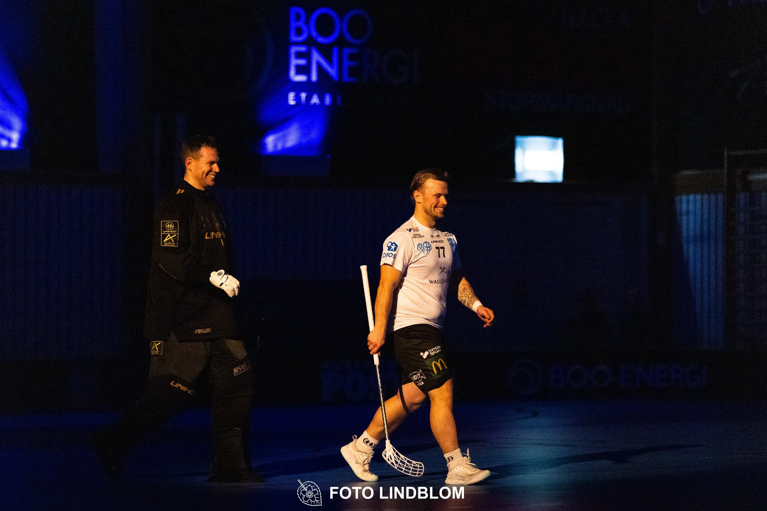 A picture of men playing floorball in Nacka IBK and FBC Sollentuna team gear