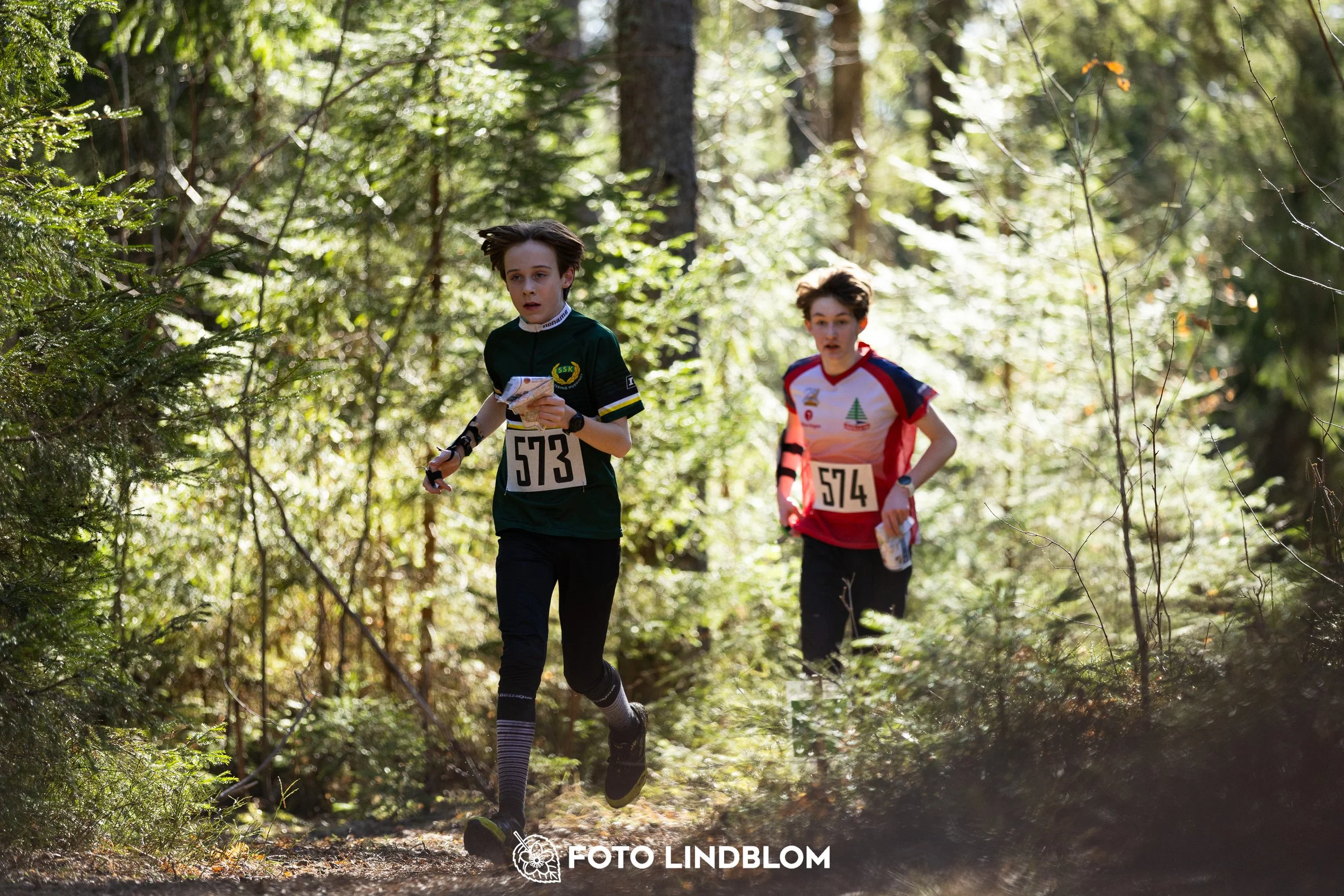 A forest-stage photo from the 2026 Nyköpingsorienteringen orienteering event, taken by Foto Lindblom.
