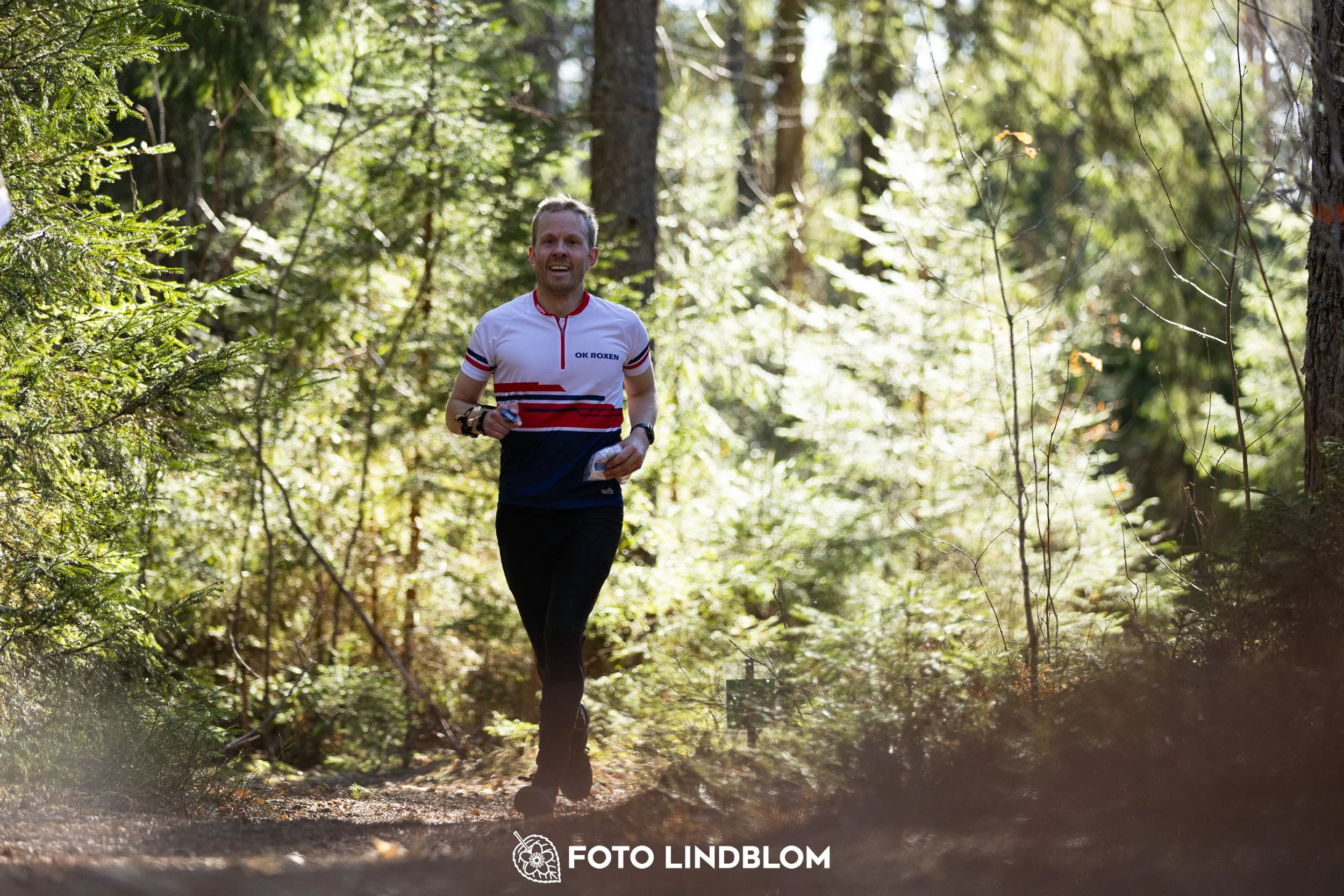 A forest-stage photo from the 2026 Nyköpingsorienteringen orienteering event, taken by Foto Lindblom.