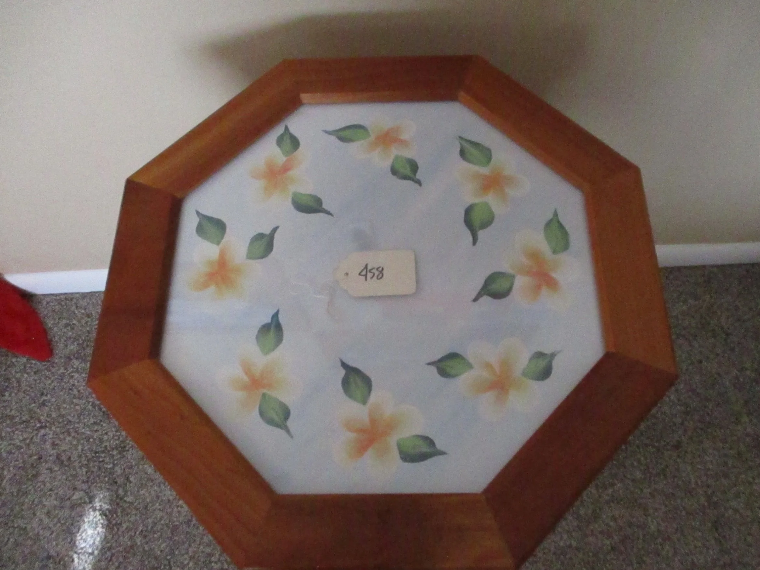 Octagonal wooden frame with floral patterned fabric top, featuring yellow-orange flowers and green leaves, and a small tag with the number 458.