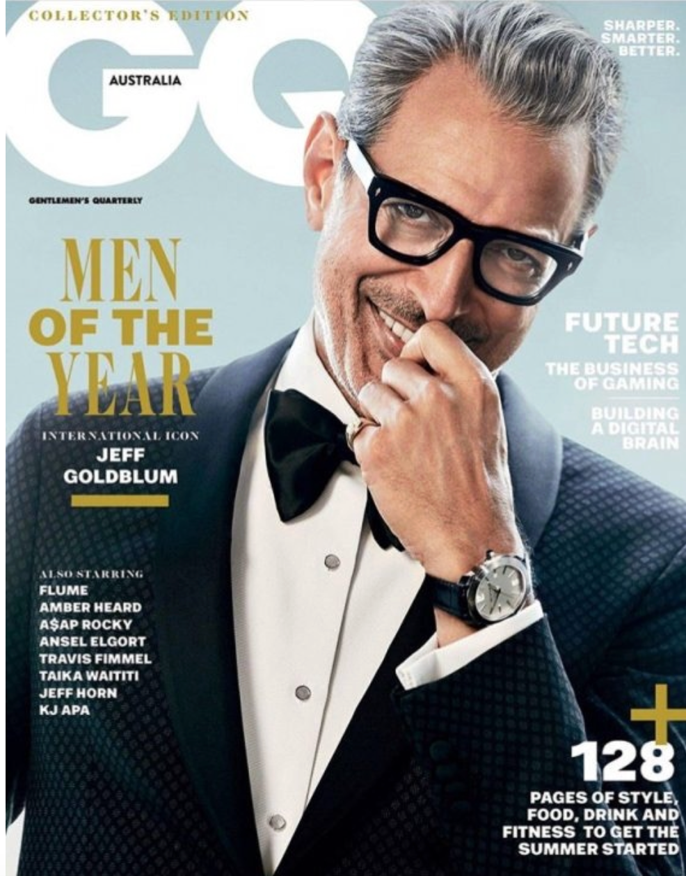 GQ magazine cover featuring a man in a tuxedo, wearing black glasses and a watch, smiling with a hand near his face. Cover headlines include "Men of the Year," "Jeff Goldblum," "Future Tech," and "128 pages of style, food, drink and fitness."