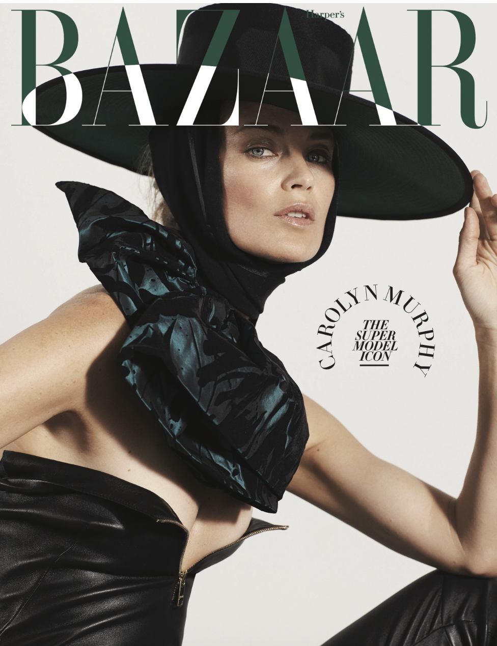 Cover of Harper's Bazaar magazine featuring model Carolyn Murphy wearing a wide-brimmed black hat, black scarf, and black leather outfit.