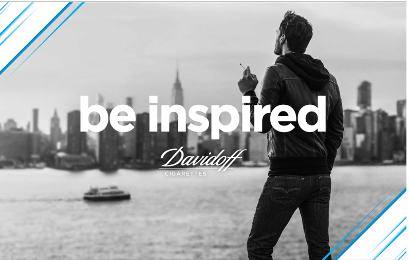 A man in a black leather jacket stands by the water holding a cigarette, facing the New York City skyline including the Empire State Building, with the message 'be inspired' and 'Davidoff Cigarettes' overlaid.