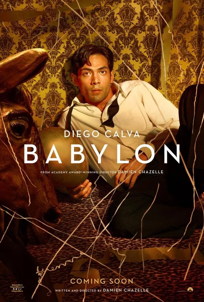 A movie poster for 'Babylon' featuring Diego Calva reclining on patterned carpets with a prop horse. The background has ornate wall coverings and scattered streamers. The poster indicates the film is coming soon and is written and directed by Damien 