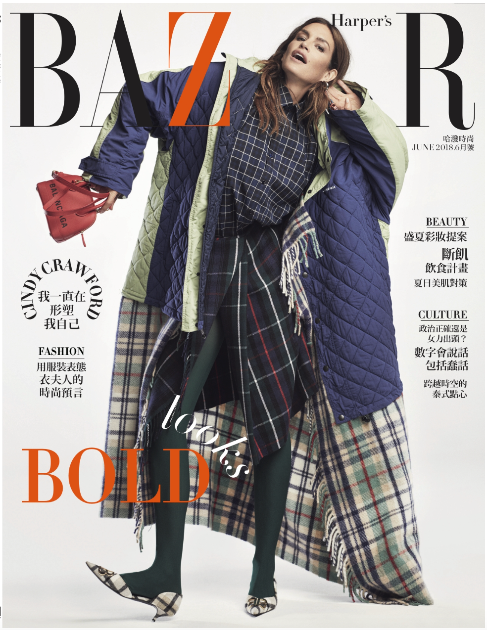Harper's Bazaar magazine cover featuring a woman in layered plaid and quilted clothing, holding a red handbag.