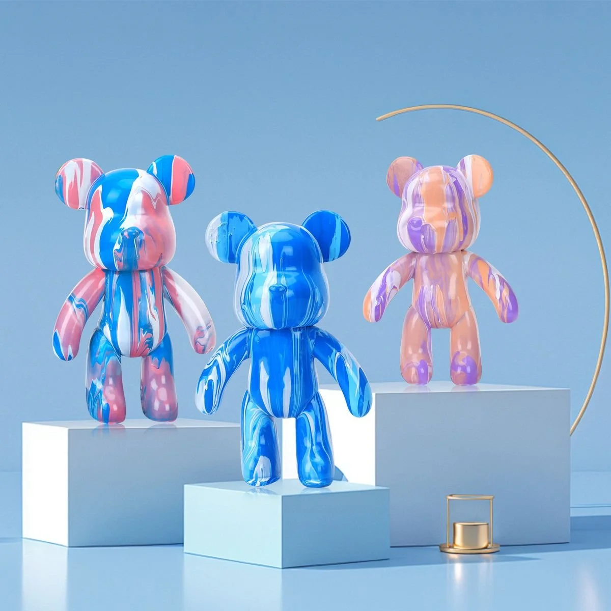 Three colorful bear-shaped sculptures with marbled patterns in pink, blue, and purple, displayed on white pedestals against a blue background, with a gold arch and small gold object nearby.
