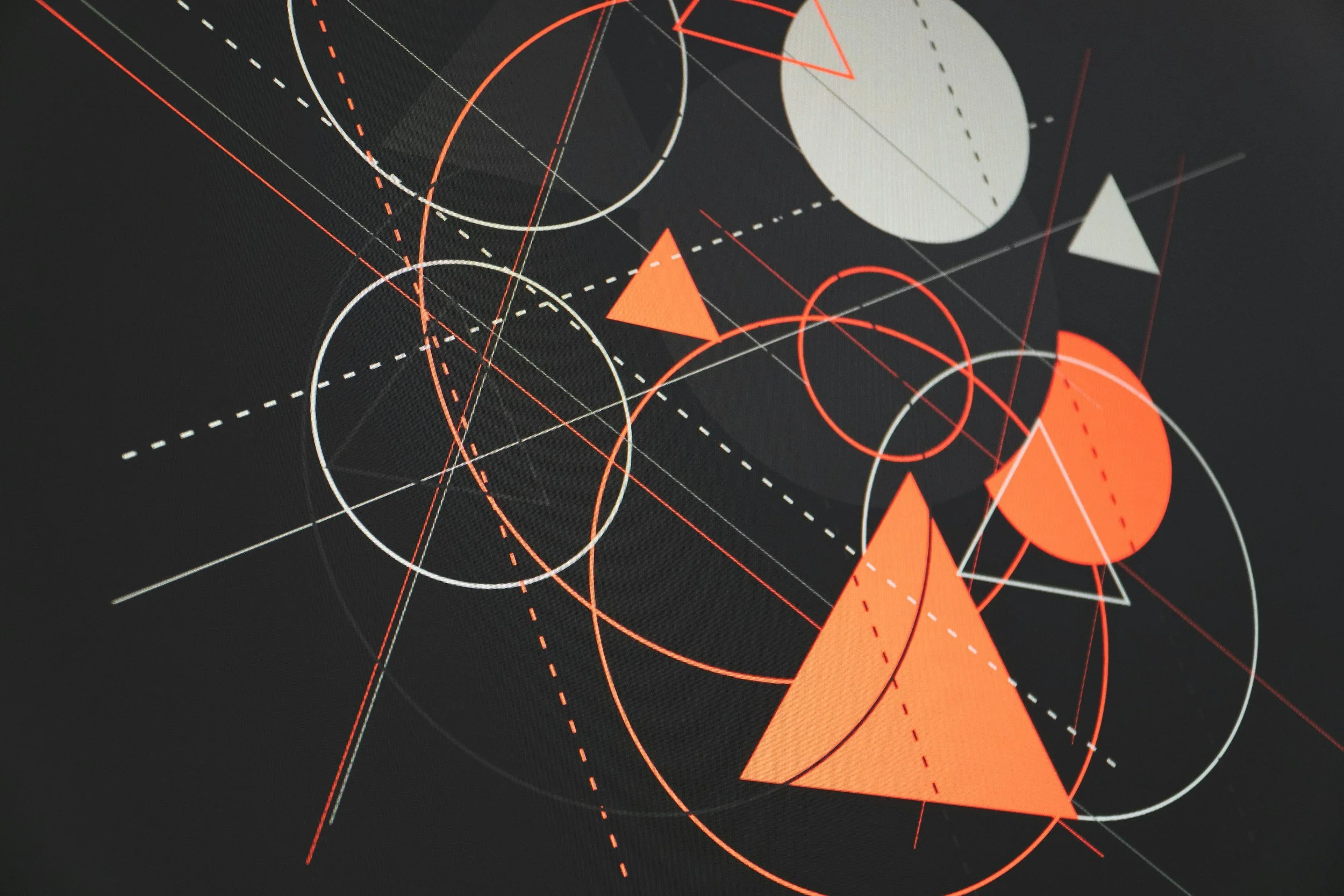 Abstract geometric design featuring circles, triangles, and lines in red, white, and gray on a black background.