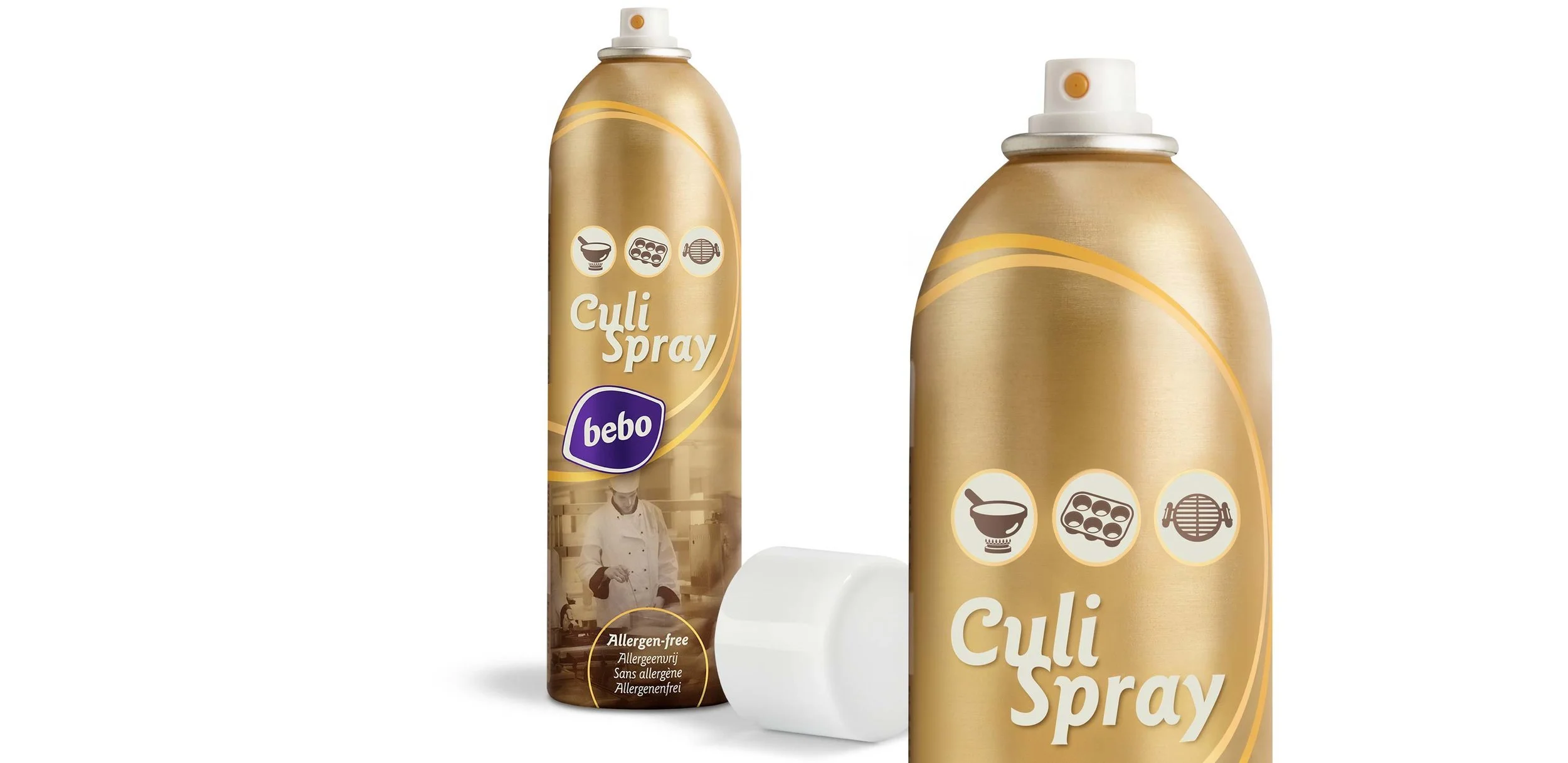 Een spuitbus Guli Spray in goudkleur met icons voor koken, bereiden van sushi of rijst, en grillen. Daarnaast ligt er een witte schraper en een ander identiek spuitbusje.