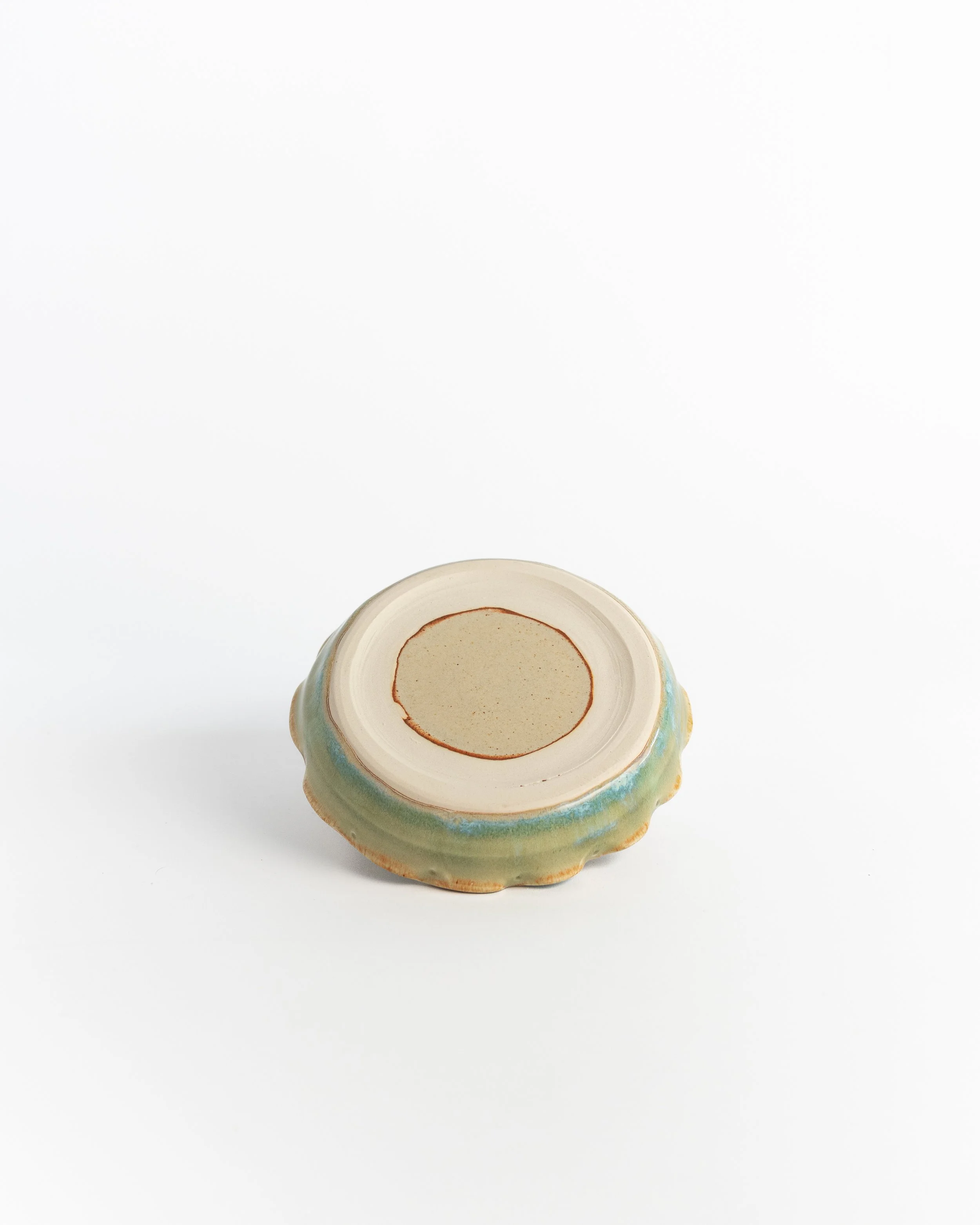 Underside of Wavelet Dish showing the unglazed foot and maker's mark.