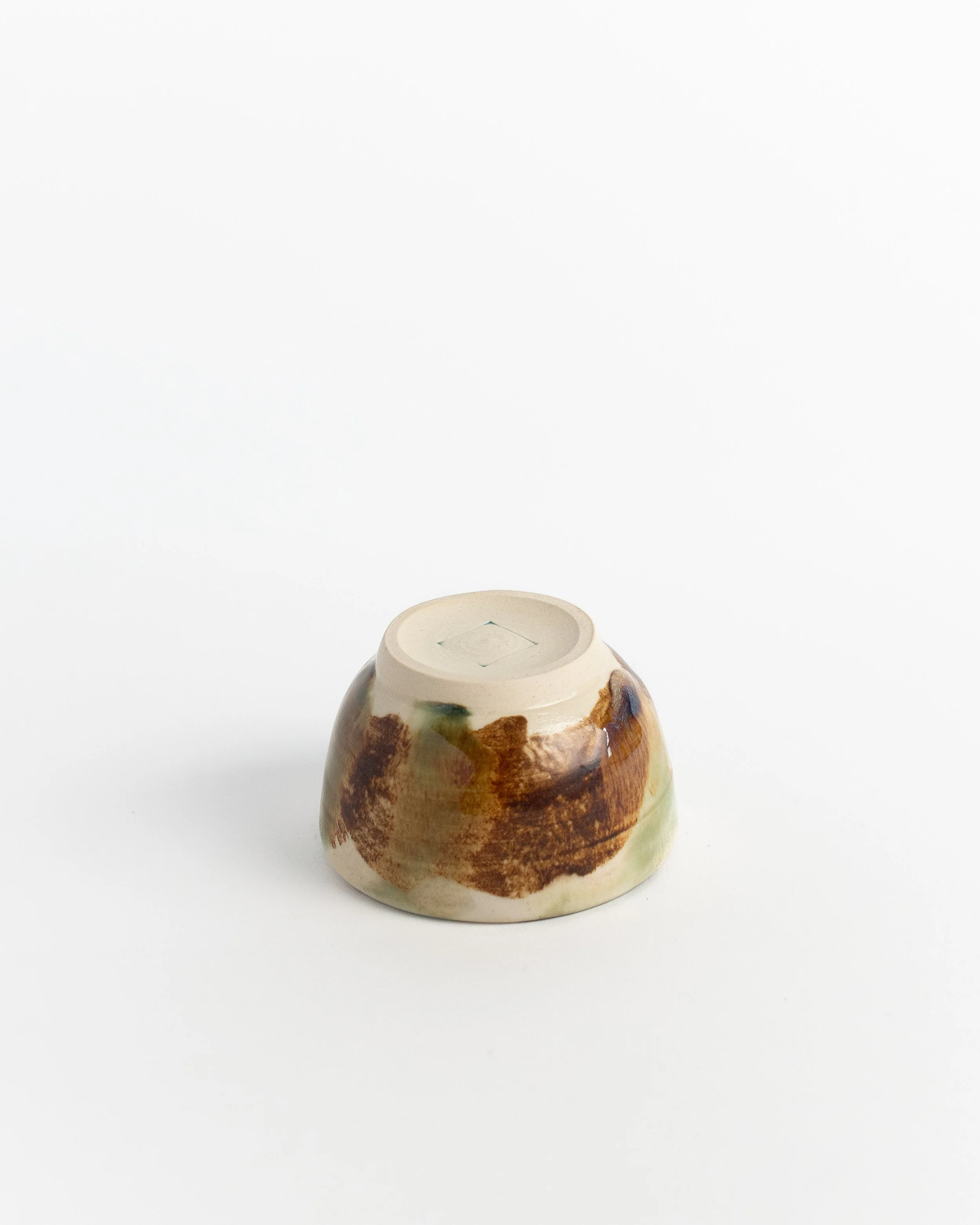 Underside of Moss & Amber showing the unglazed foot and maker's mark.