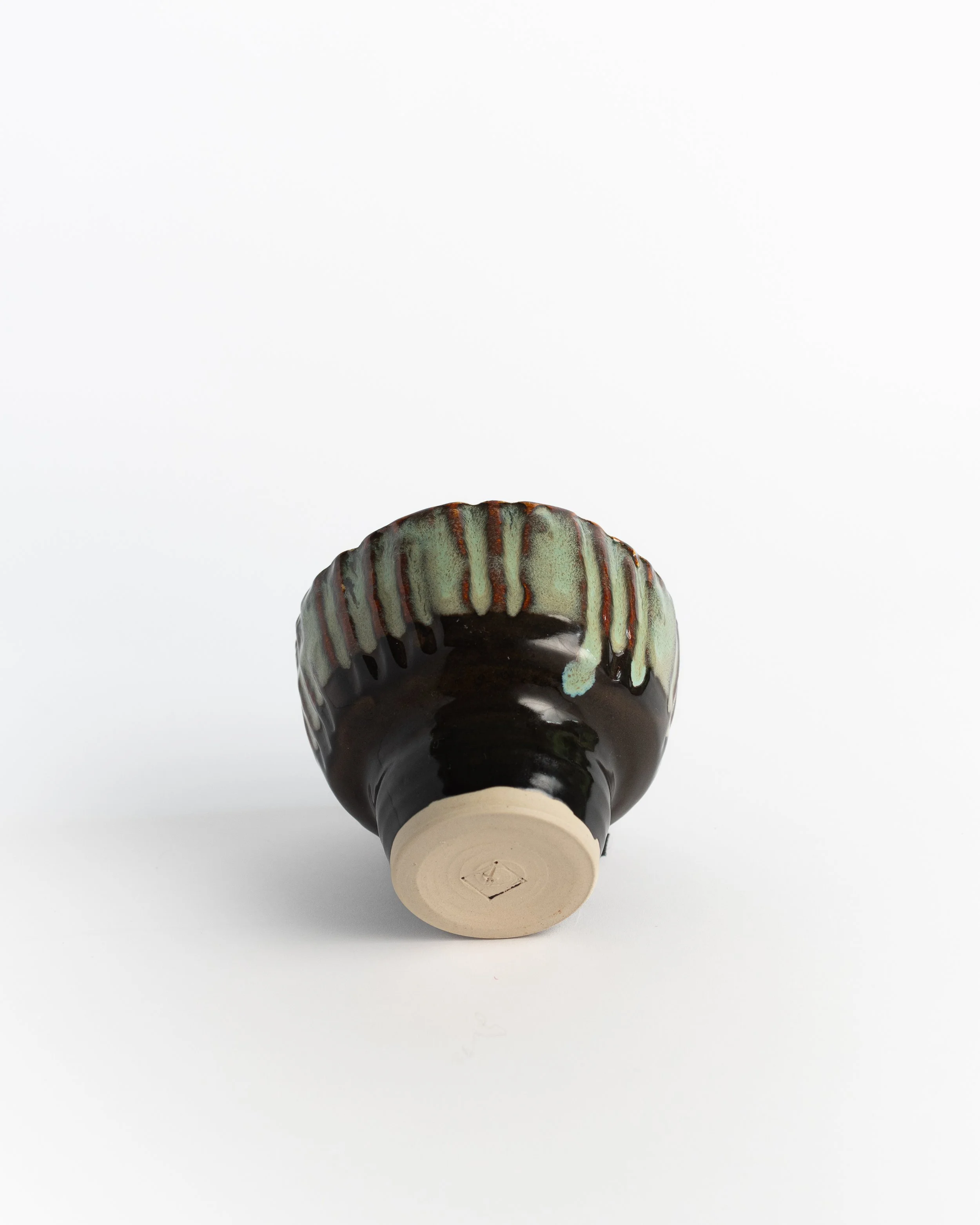 Underside of Rattle Bowl II showing the unglazed foot and maker's mark.