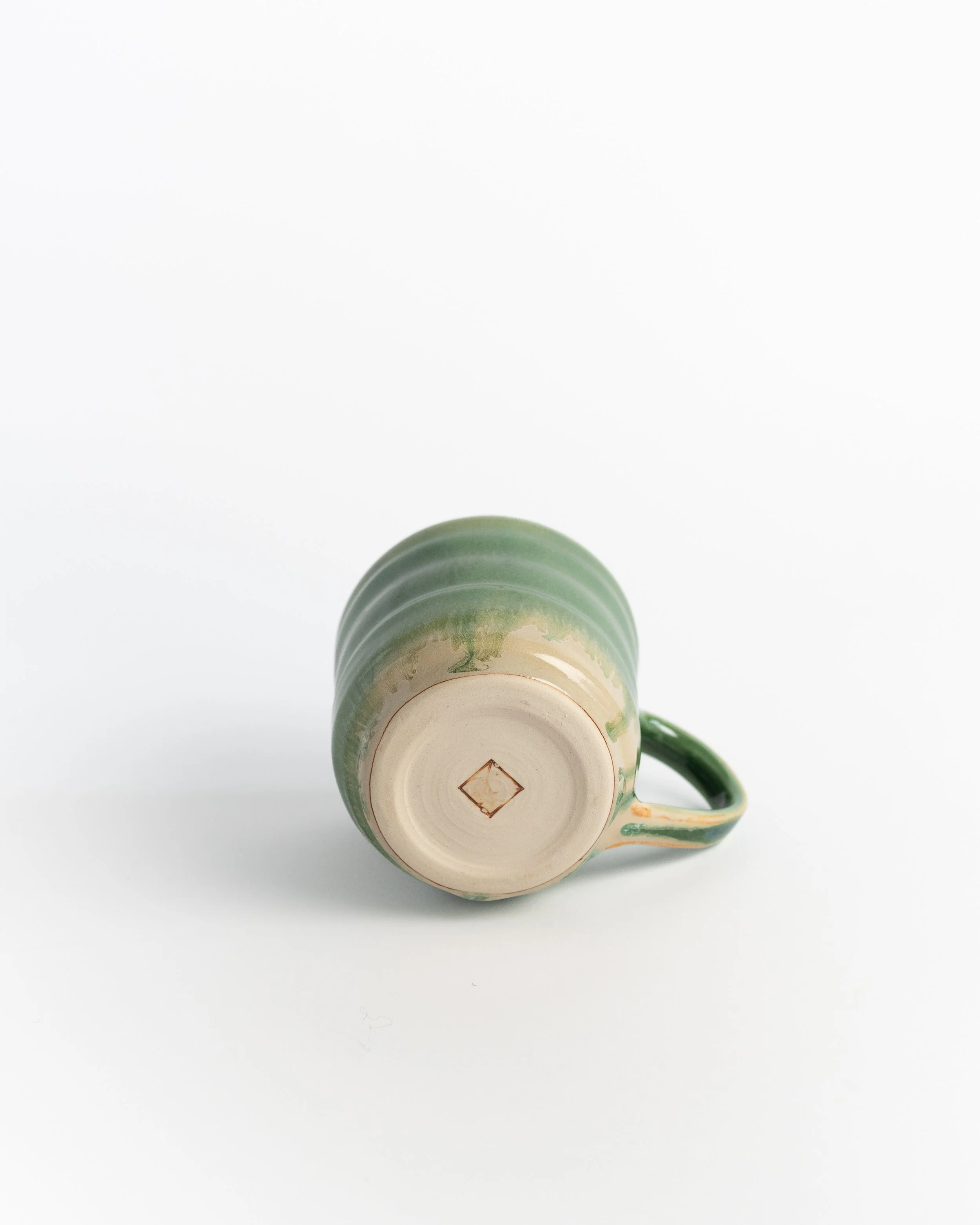 Underside of Verdant showing the unglazed foot and maker's mark.