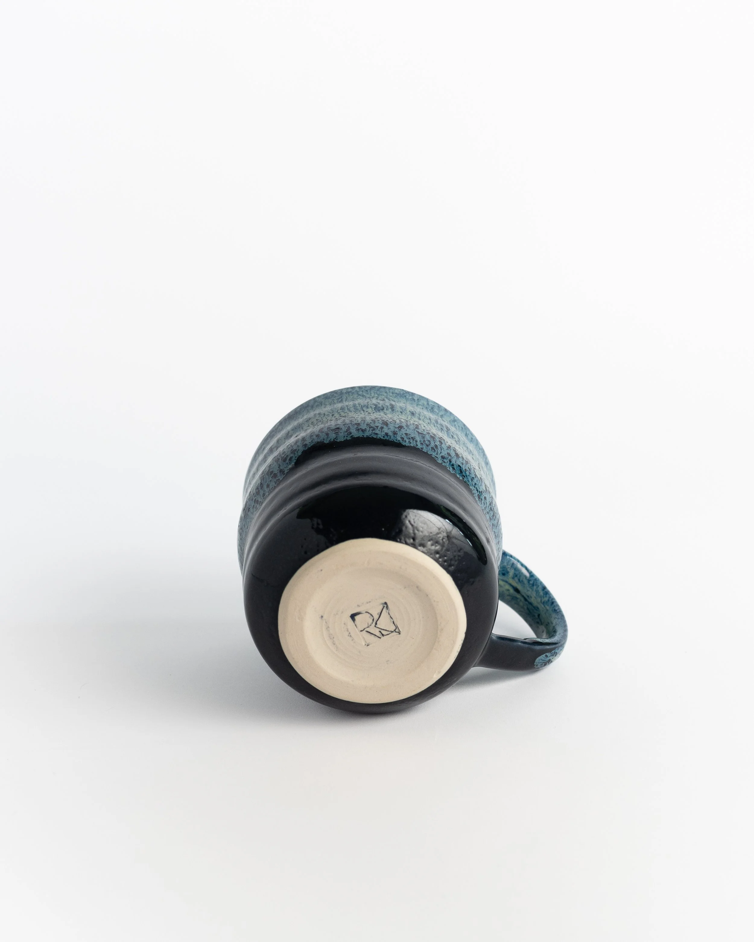 Underside of Deep Teal Mug showing the unglazed foot and maker's mark.