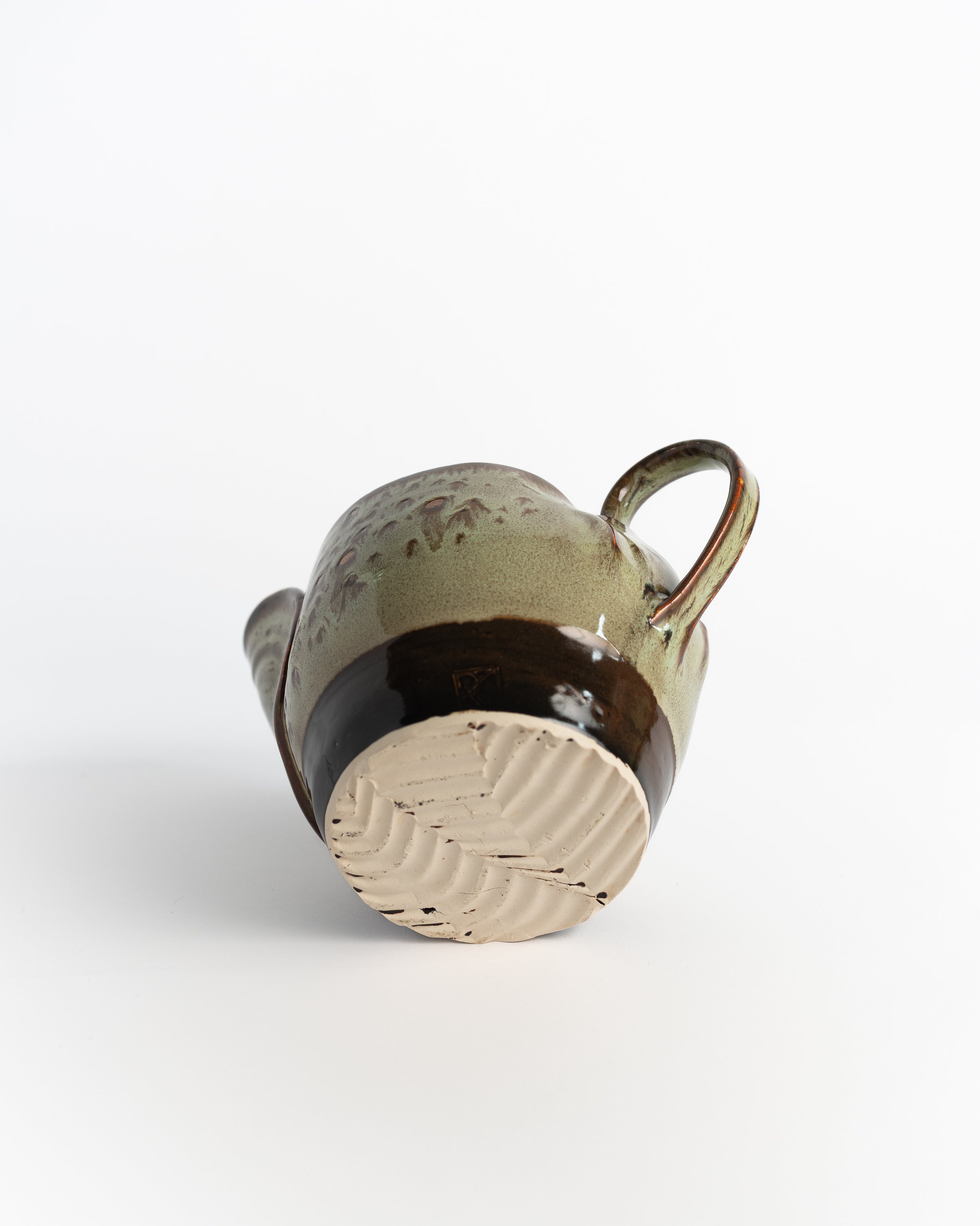 Underside of Moss Creamer showing the unglazed foot and maker's mark.