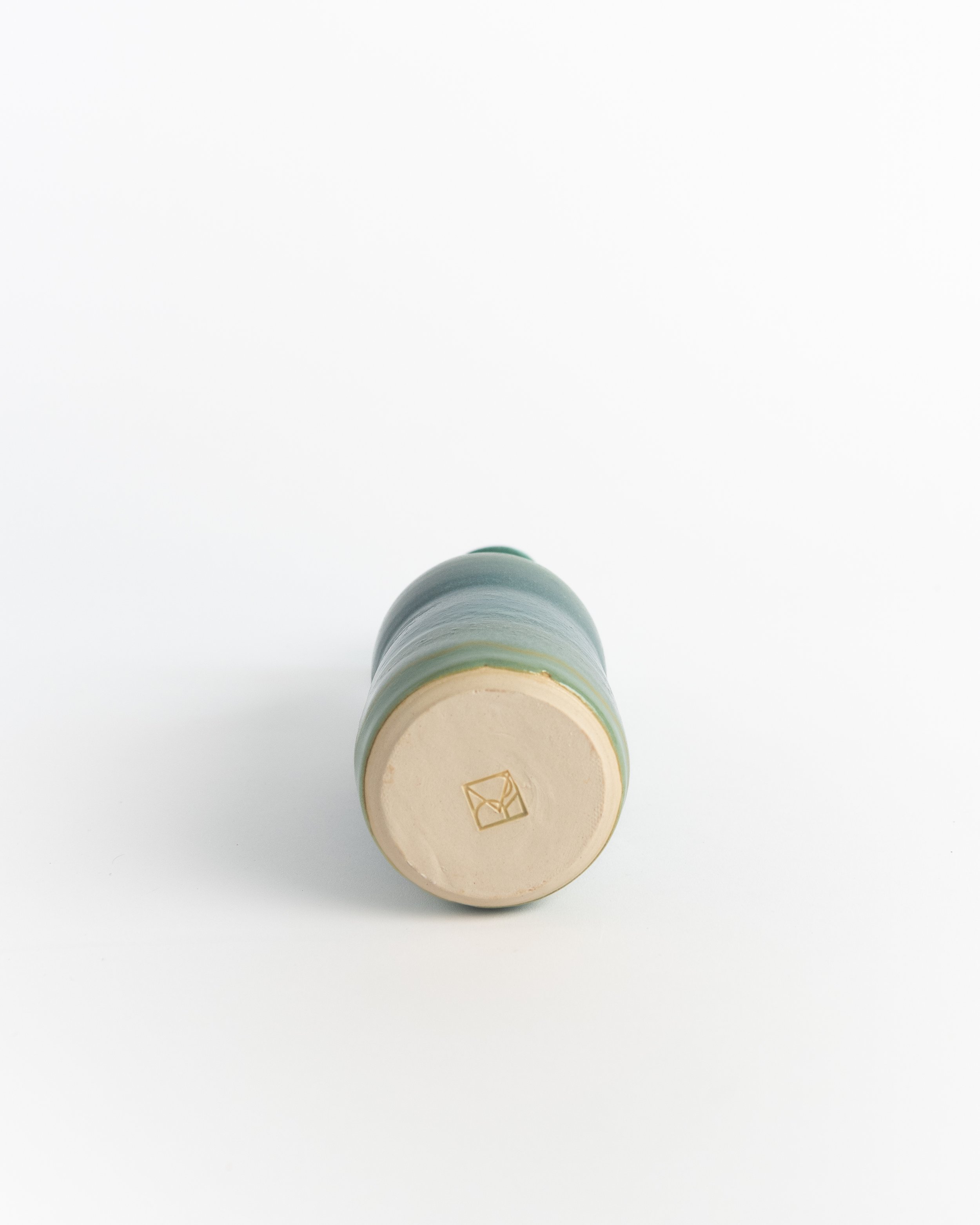 Underside of Teal Bottle showing the unglazed foot and maker's mark.