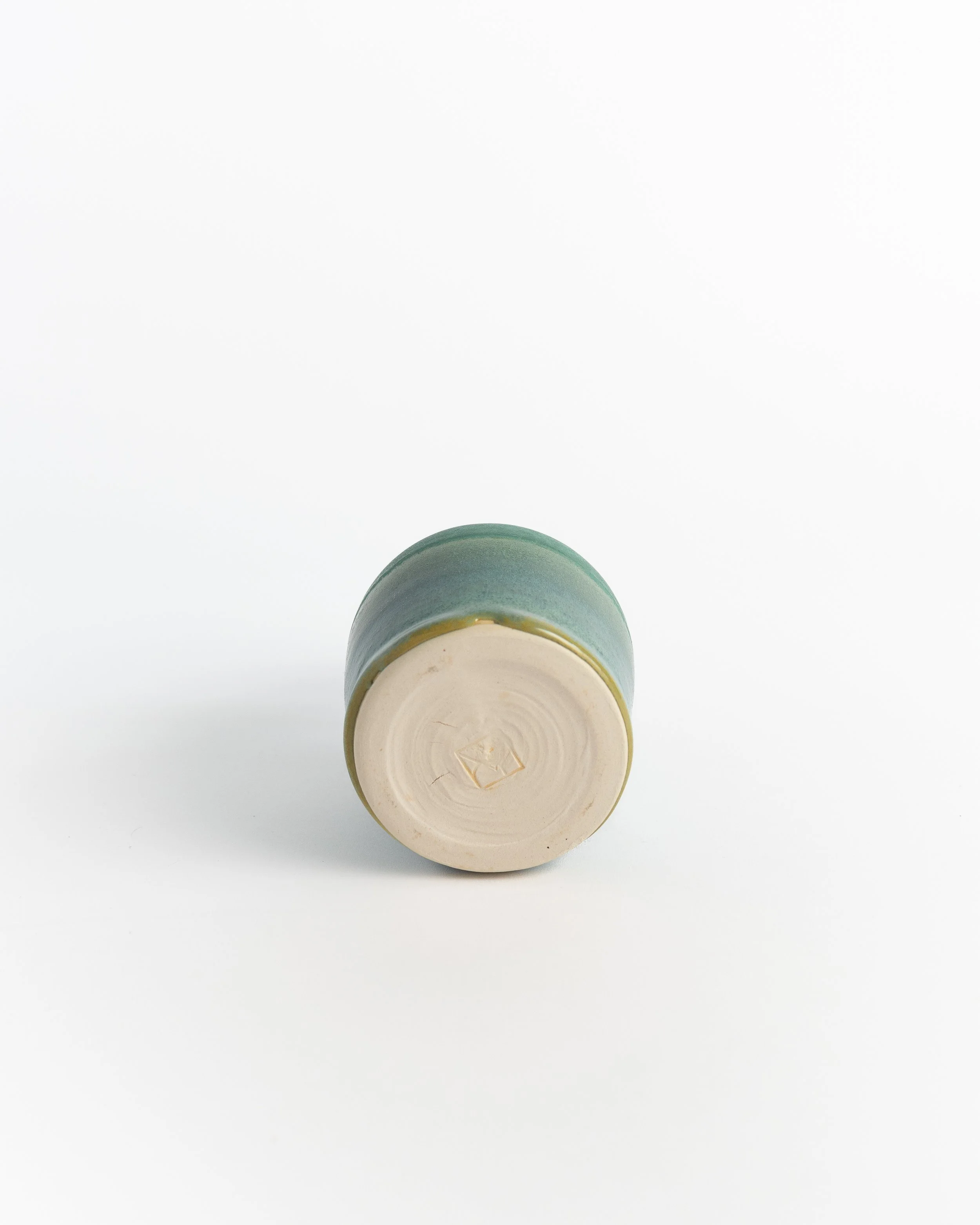 Underside of Corked Teal Bottle showing the unglazed foot and maker's mark.