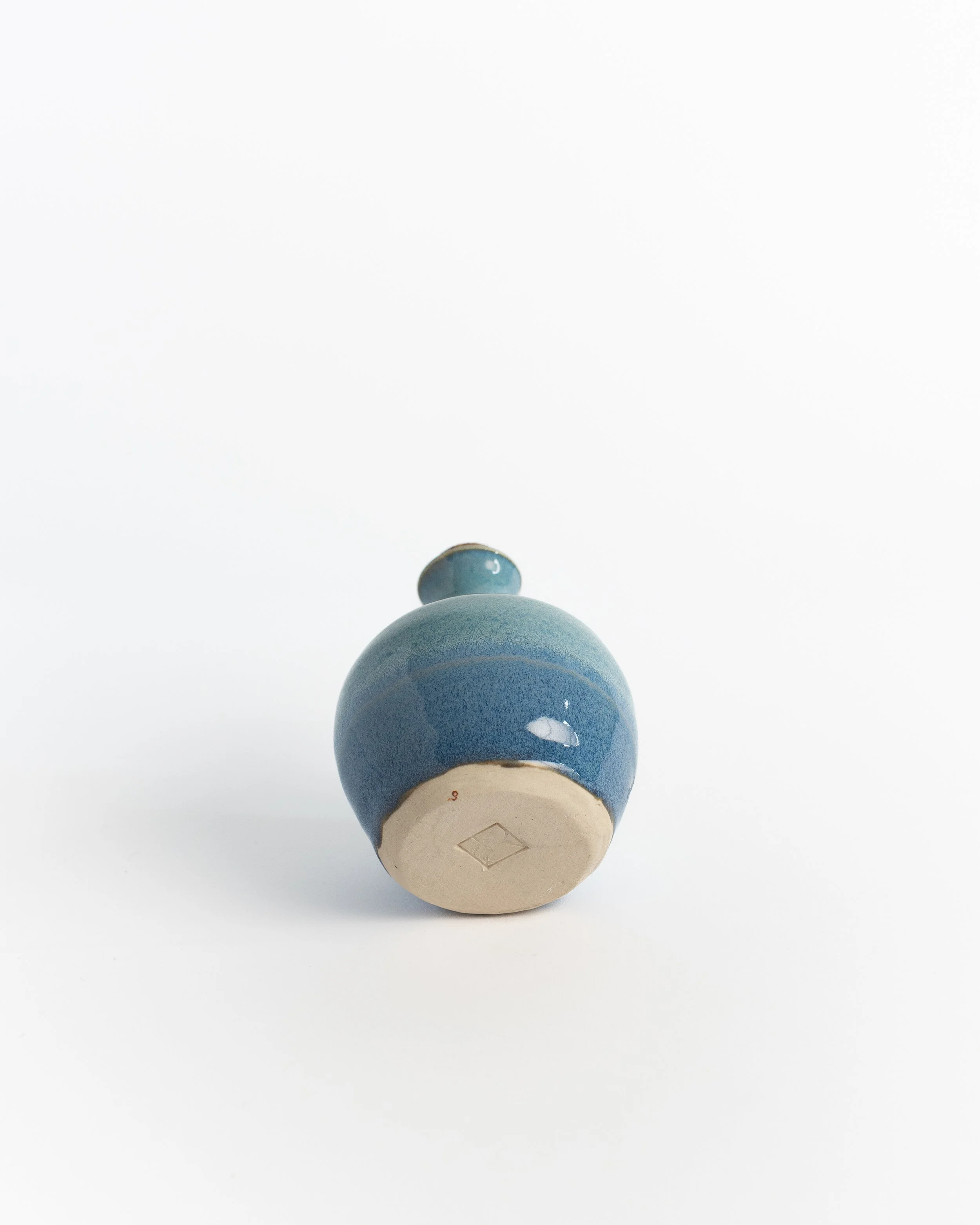 Underside of Corked Blue Bottle showing the unglazed foot and maker's mark.